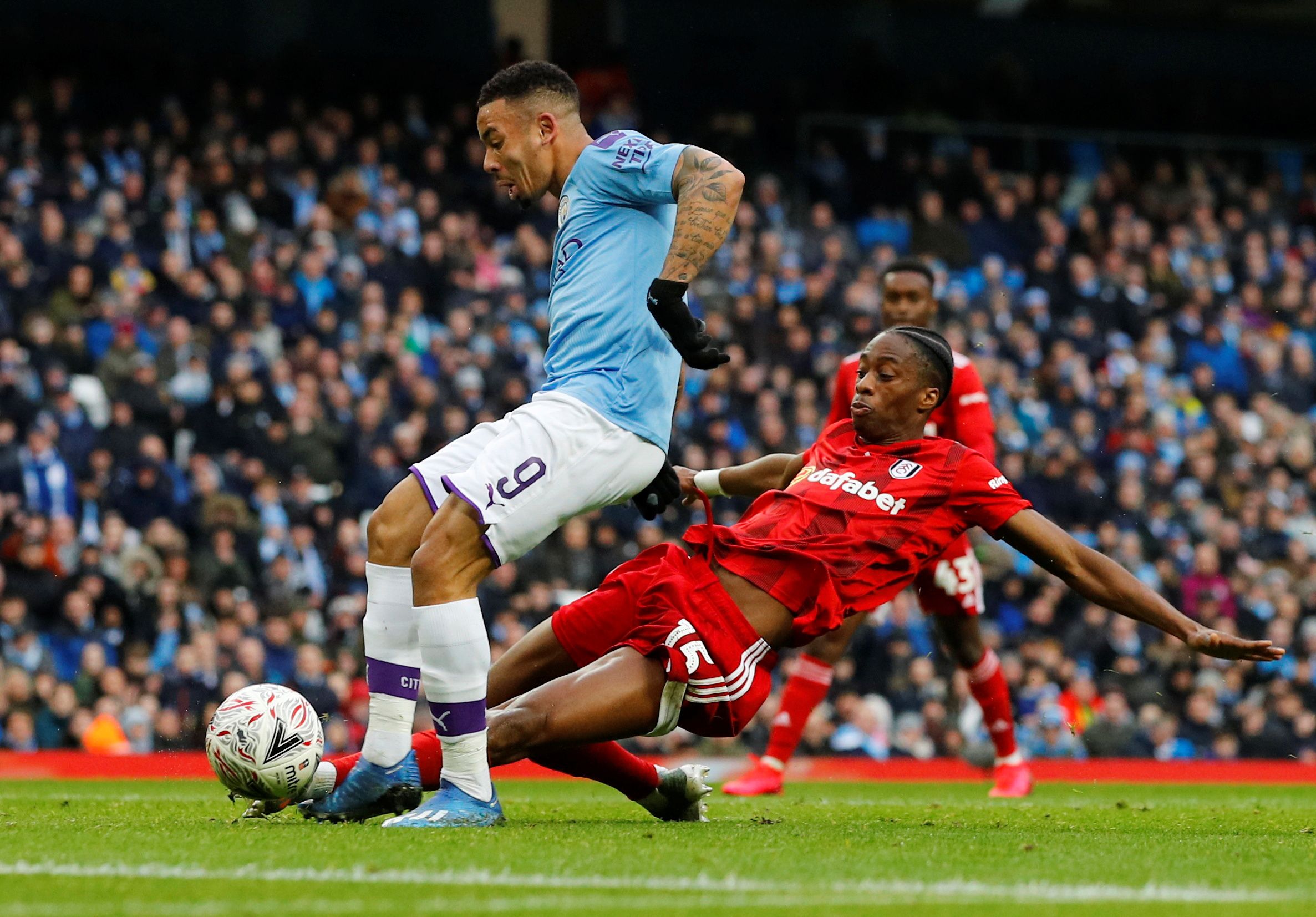 Soccer Football - FA Cup Fourth Round - Manchester City v Fulham - Etihad Stadium, Manchester, Britain - January 26, 2020  Manchester City's Gabriel Jesus in action with Fulham's Terence Kongolo  REUTERS/Phil Noble