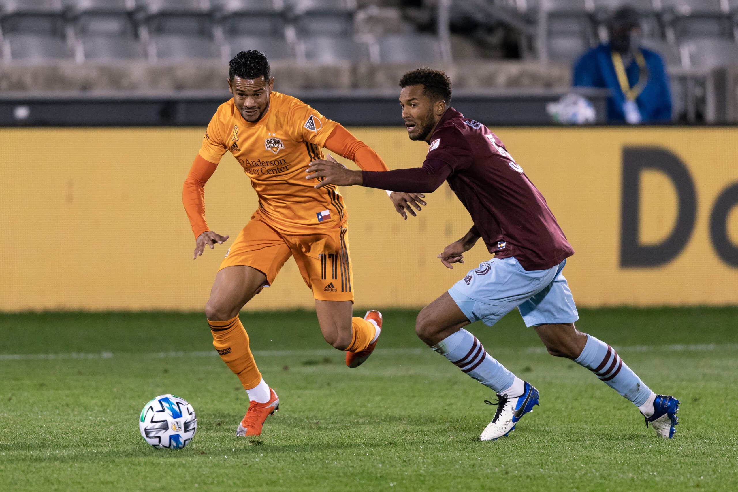 Sep 9, 2020; Commerce City, Colorado, USA; Houston Dynamo forward Ariel Lassiter (11) and Colorado Rapids defender Auston Trusty (5) battle for the ball in the second half at Dick's Sporting Goods Park. Mandatory Credit: Isaiah J. Downing-USA TODAY Sports