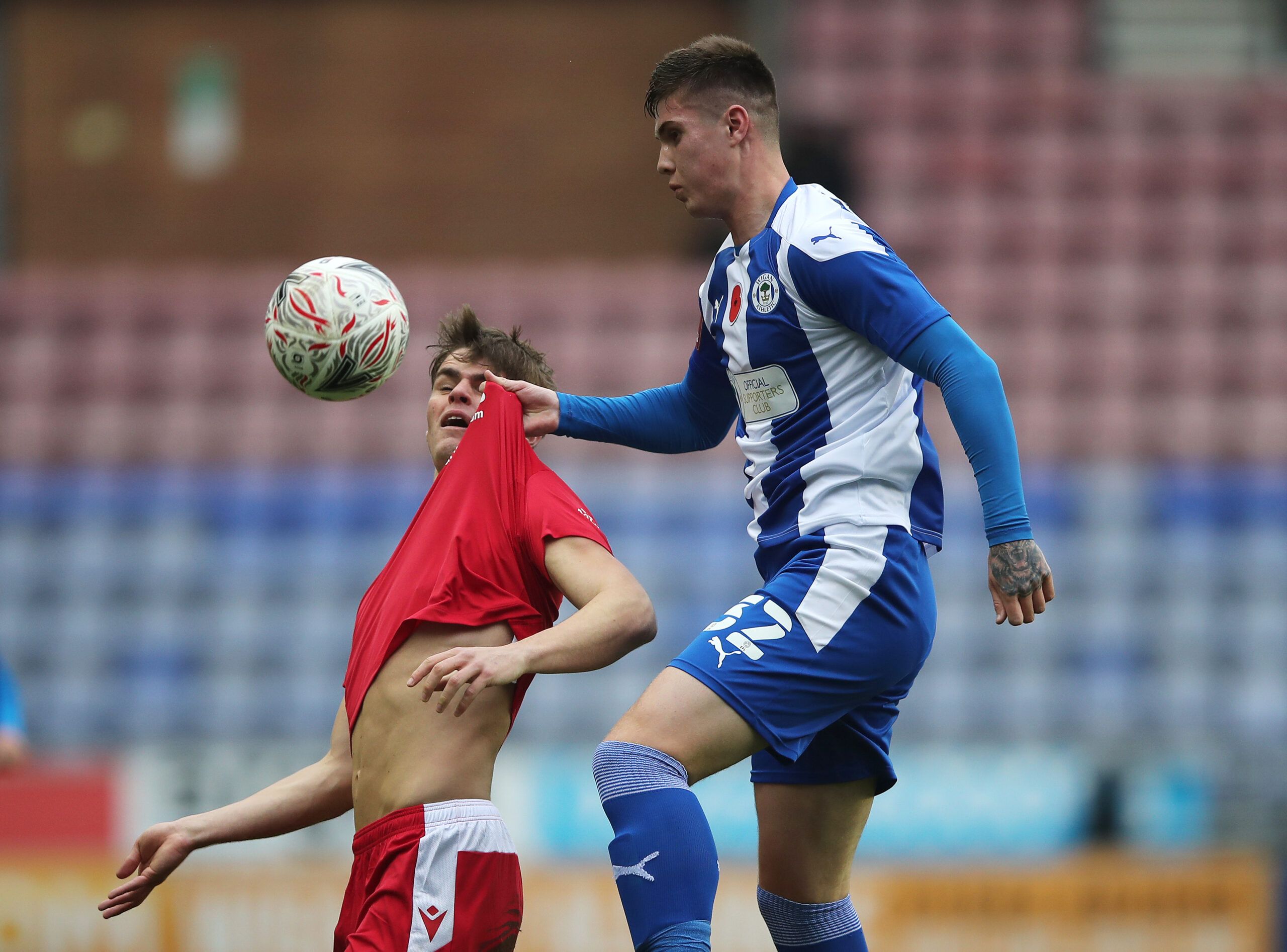 Soccer Football - FA Cup First Round - Wigan Athletic v Chorley - DW Stadium, Wigan, Britain - November 8, 2020  Chorley's Mike Calveley in action with Wigan Athletic's Adam Long Action Images/Molly Darlington