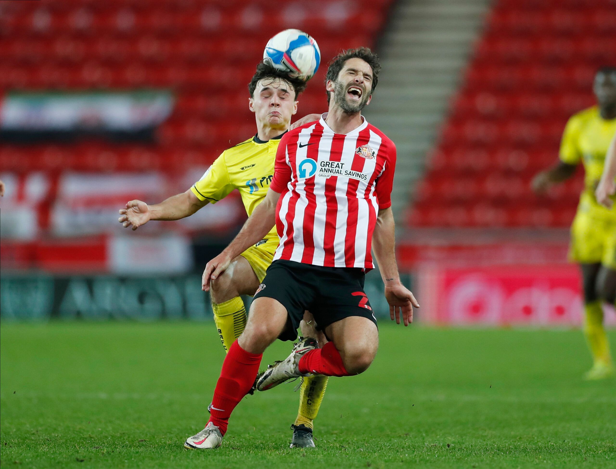 Soccer Football - League One - Sunderland v Burton Albion - Stadium of Light, Sunderland, Britain - December 1, 2020 Sunderland's Will Grigg in action with Burton Albion's Ciaran Gilligan Action Images/Lee Smith EDITORIAL USE ONLY. No use with unauthorized audio, video, data, fixture lists, club/league logos or 'live' services. Online in-match use limited to 75 images, no video emulation. No use in betting, games or single club /league/player publications.  Please contact your account representa