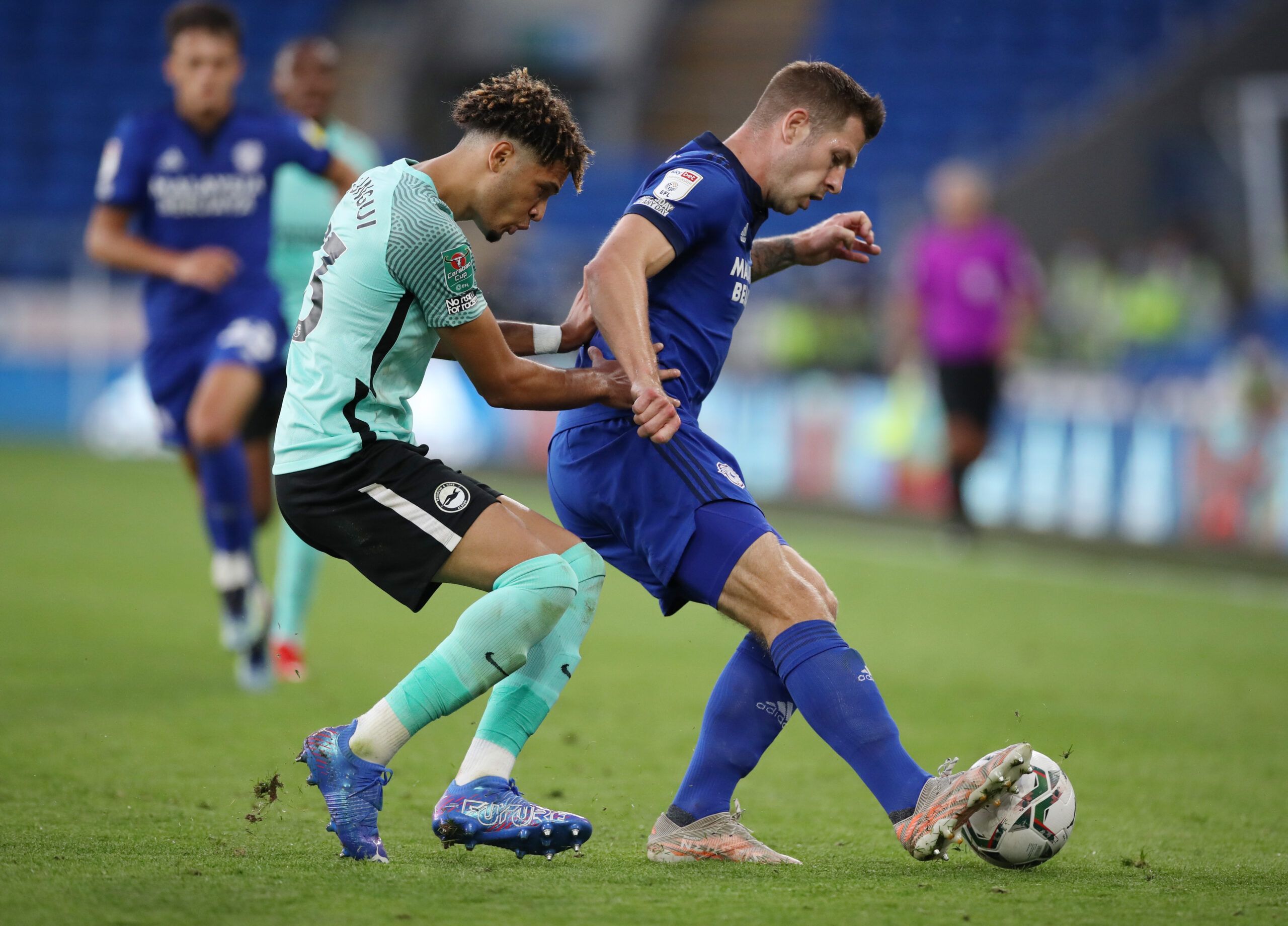 Soccer - England - Carabao Cup Second Round - Cardiff City v Brighton &amp; Hove Albion - Cardiff City Stadium, Cardiff, Britain - August 24, 2021 Cardiff City's James Collins in action with Brighton &amp; Hove Albion's Antef Tsoungui Action Images via Reuters/Peter Cziborra