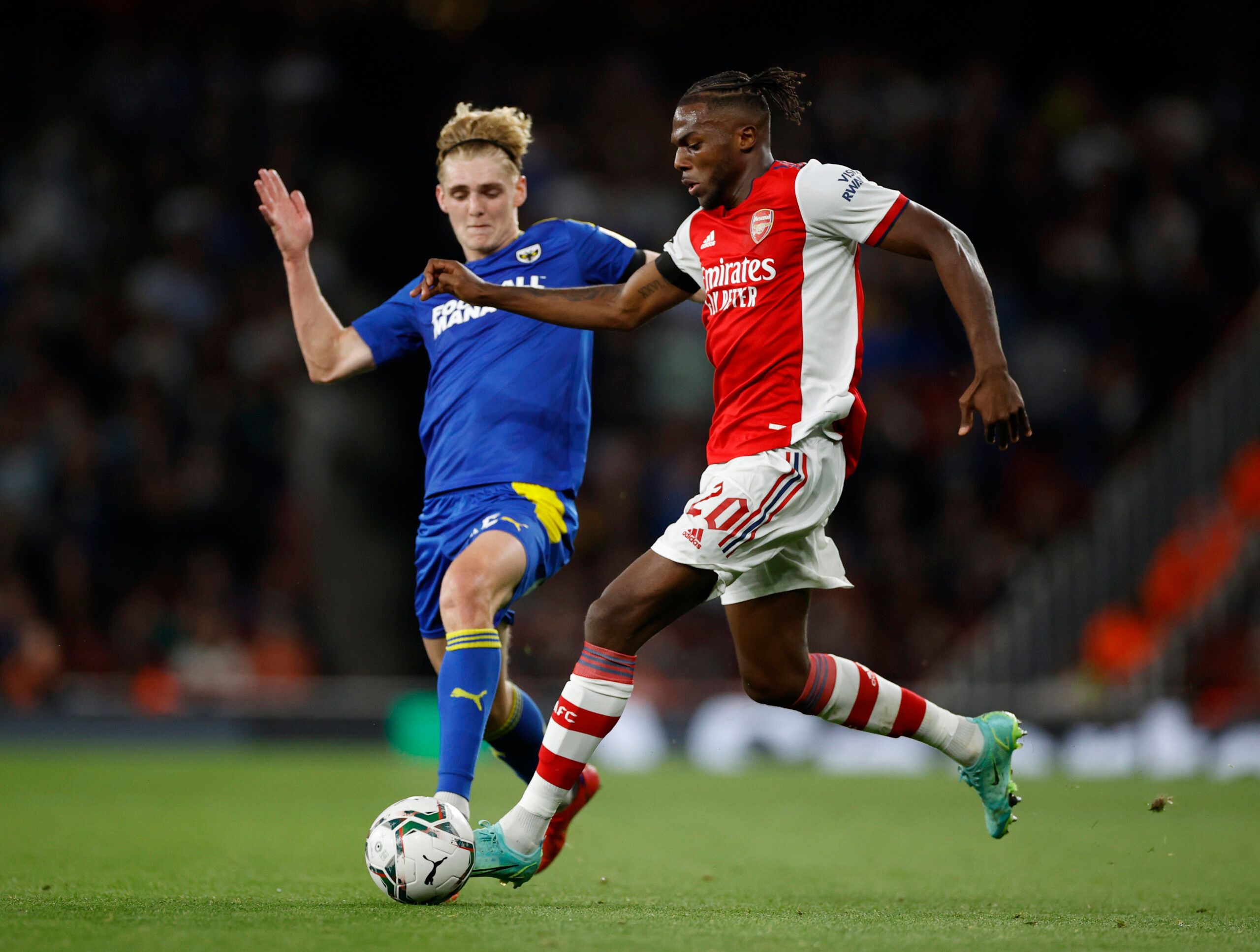 Soccer Football - Carabao Cup - Third Round - Arsenal v AFC Wimbledon - Emirates Stadium, London, Britain - September 22, 2021 AFC Wimbledon's Jack Rudoni in action with Arsenal's Nuno Tavares Action Images via Reuters/John Sibley EDITORIAL USE ONLY. No use with unauthorized audio, video, data, fixture lists, club/league logos or 'live' services. Online in-match use limited to 75 images, no video emulation. No use in betting, games or single club /league/player publications.  Please contact your