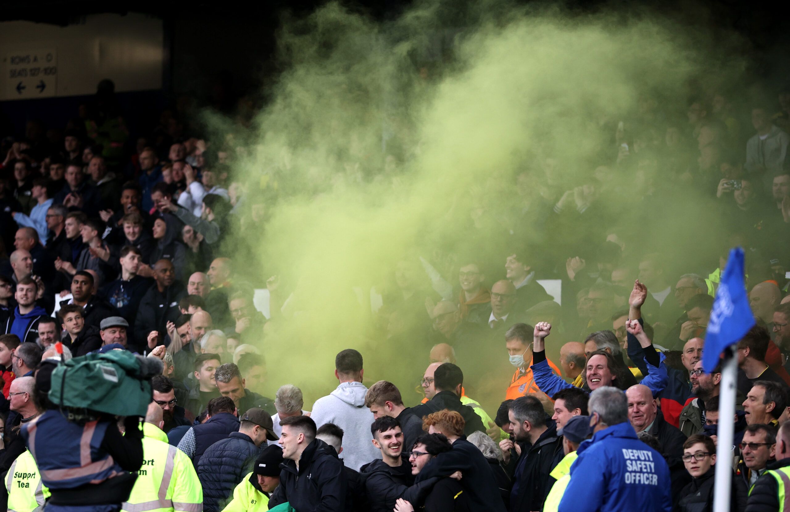Soccer - England - Premier League - Everton v Watford - Goodison Park, Liverpool, Britain - October 23, 2021 Watford fans with a flare inside the stadium during the match Action Images via Reuters/Molly Darlington EDITORIAL USE ONLY. No use with unauthorized audio, video, data, fixture lists, club/league logos or 'live' services. Online in-match use limited to 75 images, no video emulation. No use in betting, games or single club /league/player publications.  Please contact your account represen