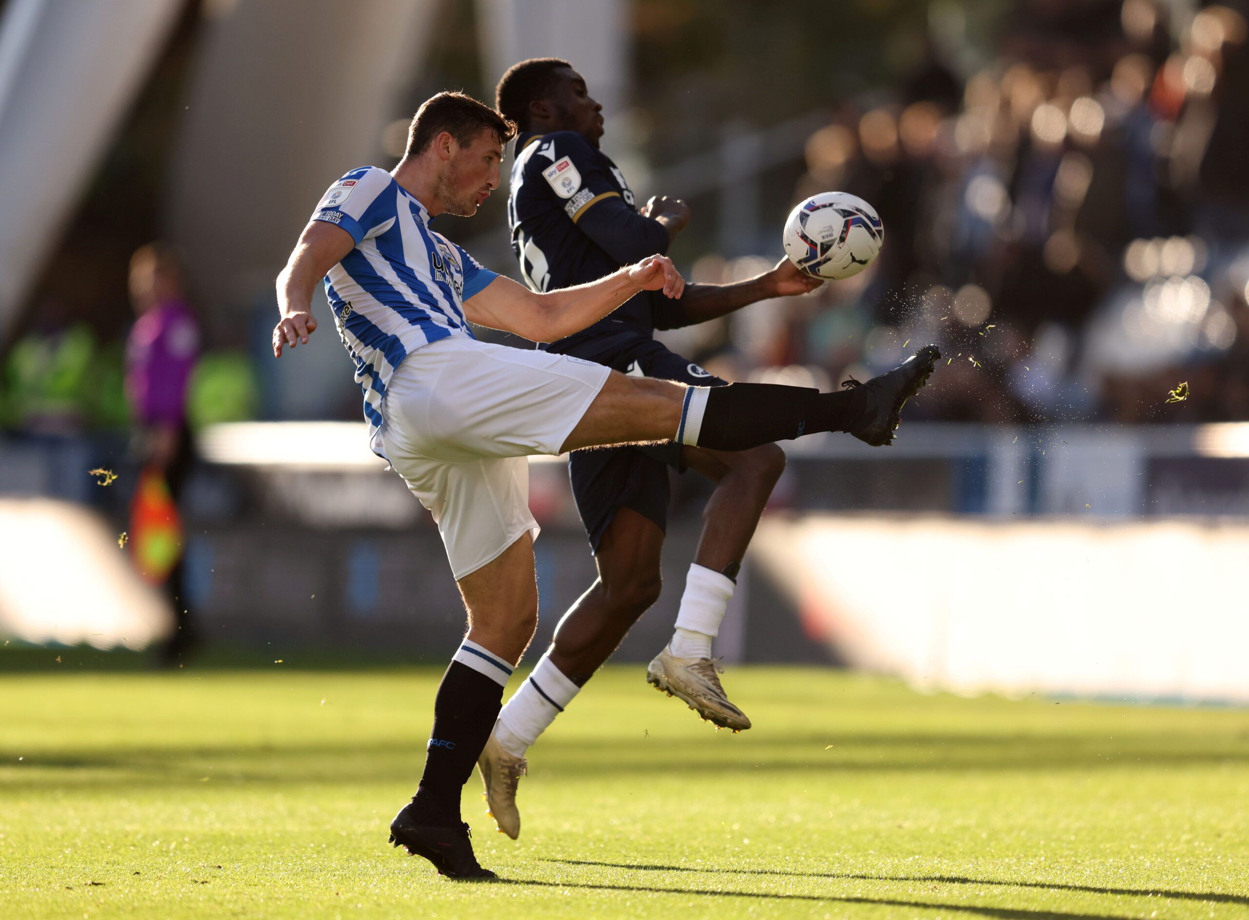 Soccer Football - Championship - Huddersfield Town v Millwall - John Smith's Stadium, Huddersfield, Britain - October 30, 2021 Huddersfield Town's Matty Pearson clears from Millwall's Sheyi Ojo  Action Images/John Clifton  EDITORIAL USE ONLY. No use with unauthorized audio, video, data, fixture lists, club/league logos or 