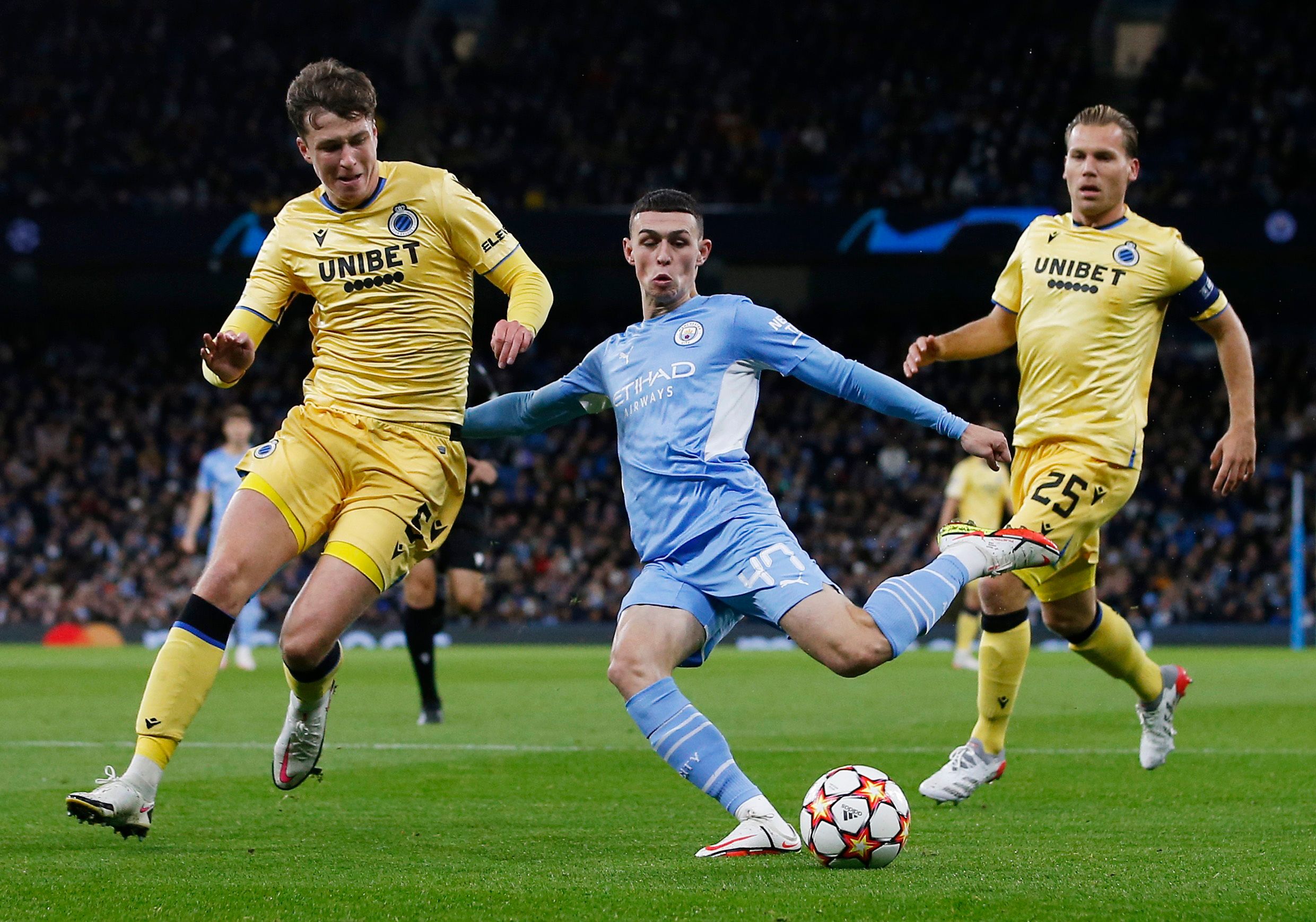 Soccer Football - Champions League - Group A - Manchester City v Club Brugge - Etihad Stadium, Manchester, Britain - November 3, 2021 Manchester City's Phil Foden in action with Club Brugge's Jack Hendry and Ruud Vormer REUTERS/Craig Brough