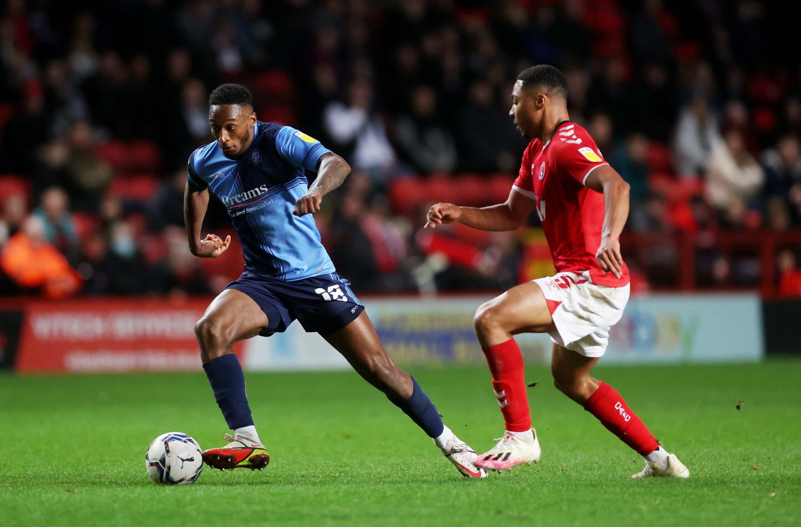 Soccer Football - League One - Charlton Athletic v Wycombe Wanderers - The Valley, London, Britain - January 1, 2022 Charlton Athletic's Akin Famewo in action with Wycombe Wanderers' Brandon Hanlan   Action Images/Matthew Childs  EDITORIAL USE ONLY. No use with unauthorized audio, video, data, fixture lists, club/league logos or 