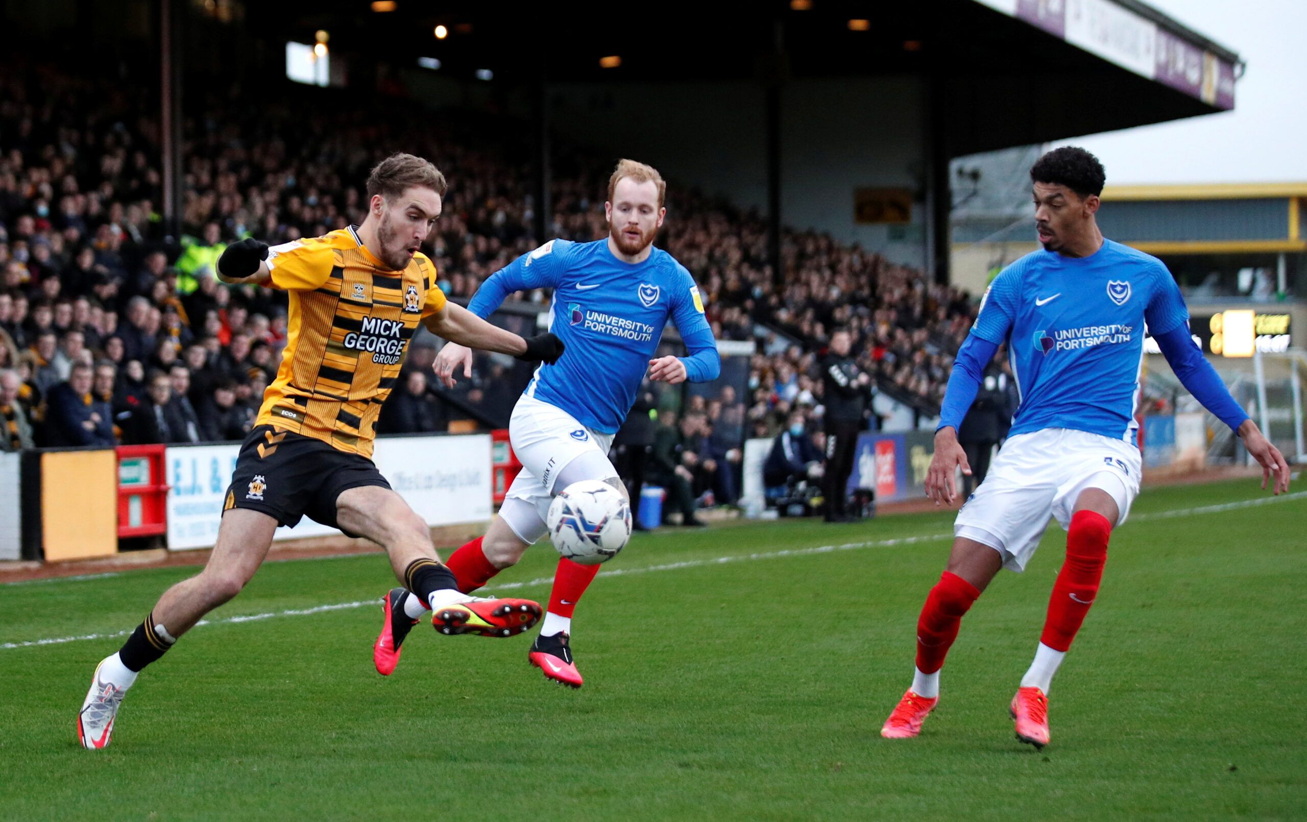 Soccer Football - League One - Cambridge United v Portsmouth - Abbey Stadium, Cambridge, Britain - January 3, 2022 Cambridge United's Sam Smith in action with Portsmouth's Reeco Hackett    Action Images/Andrew Boyers  EDITORIAL USE ONLY. No use with unauthorized audio, video, data, fixture lists, club/league logos or 