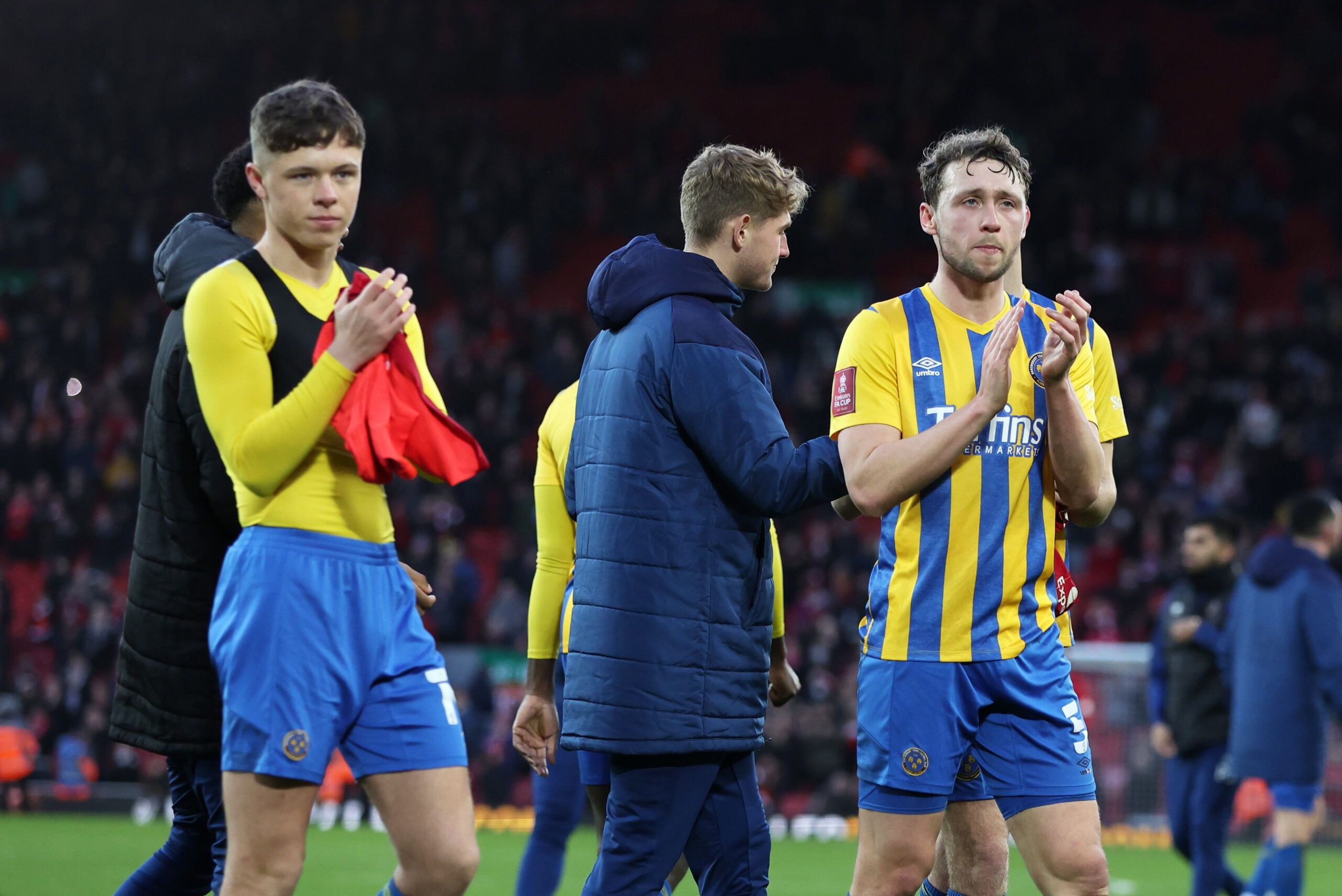 Soccer Football - FA Cup Third Round - Liverpool v Shrewsbury Town - Anfield, Liverpool, Britain - January 9, 2022 Shrewsbury Town's Matthew Pennington applauds fans after the match REUTERS/Phil Noble