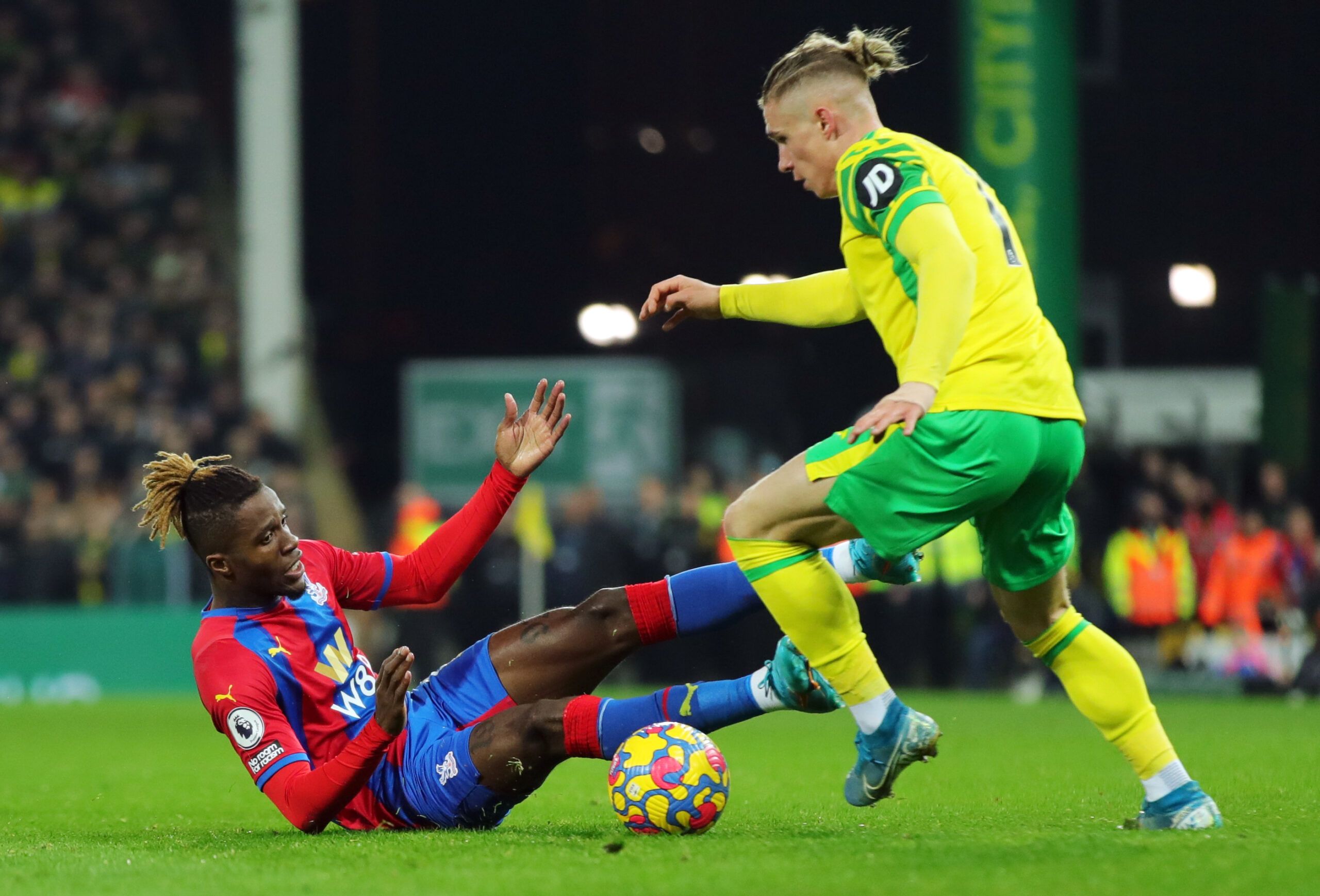 Soccer Football - Premier League - Norwich City v Crystal Palace - Carrow Road, Norwich, Britain - February 9, 2022 Crystal Palace's Wilfried Zaha in action with Norwich City's Przemyslaw Placheta REUTERS/Chris Radburn EDITORIAL USE ONLY. No use with unauthorized audio, video, data, fixture lists, club/league logos or 'live' services. Online in-match use limited to 75 images, no video emulation. No use in betting, games or single club /league/player publications.  Please contact your account rep