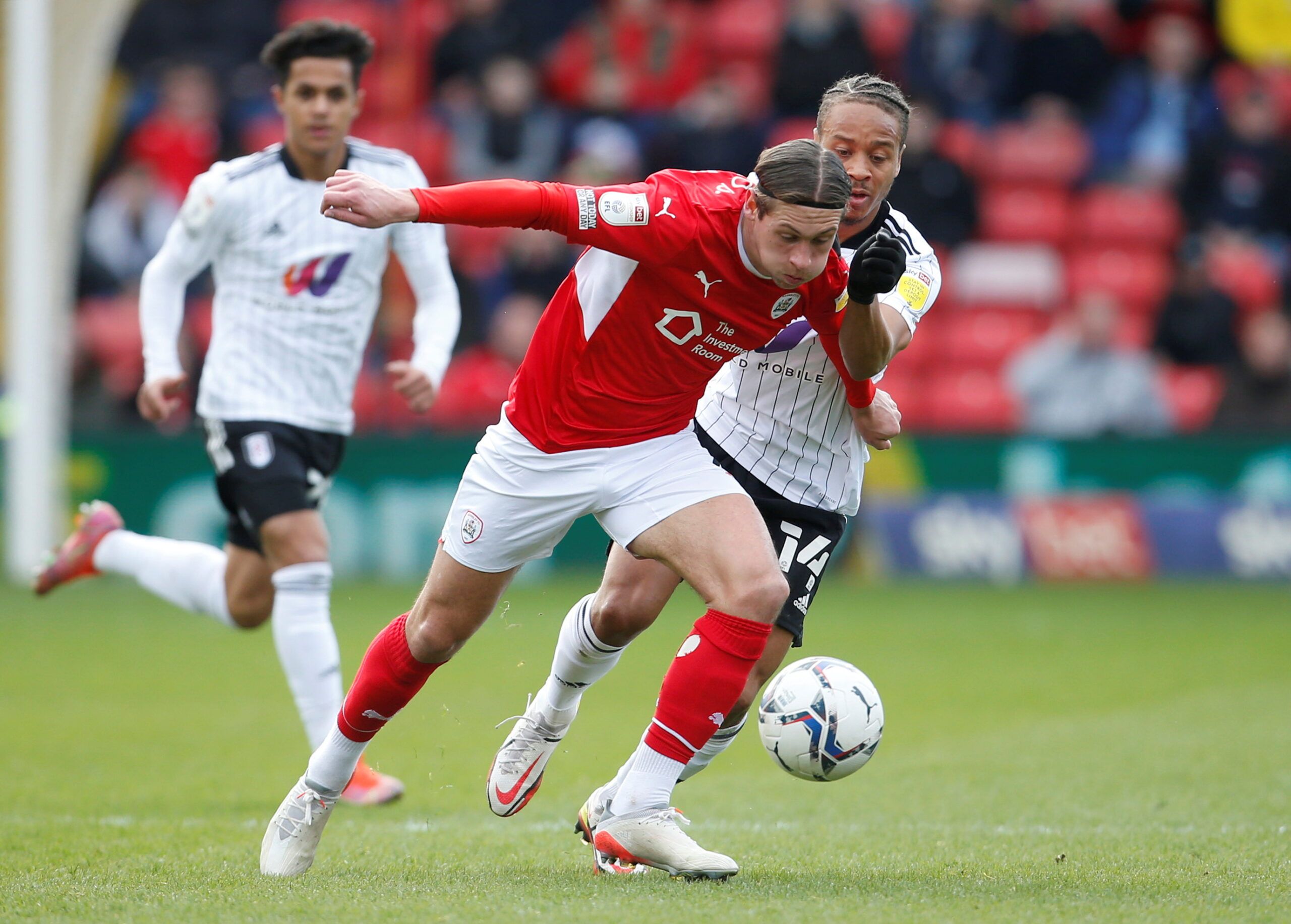Soccer Football - Championship - Barnsley v Fulham - Oakwell, Barnsley, Britain - March 12, 2022   Barnsley's Callum Brittain in action with Fulham's Bobby Decordova-Reid  Action Images/Ed Sykes  EDITORIAL USE ONLY. No use with unauthorized audio, video, data, fixture lists, club/league logos or 