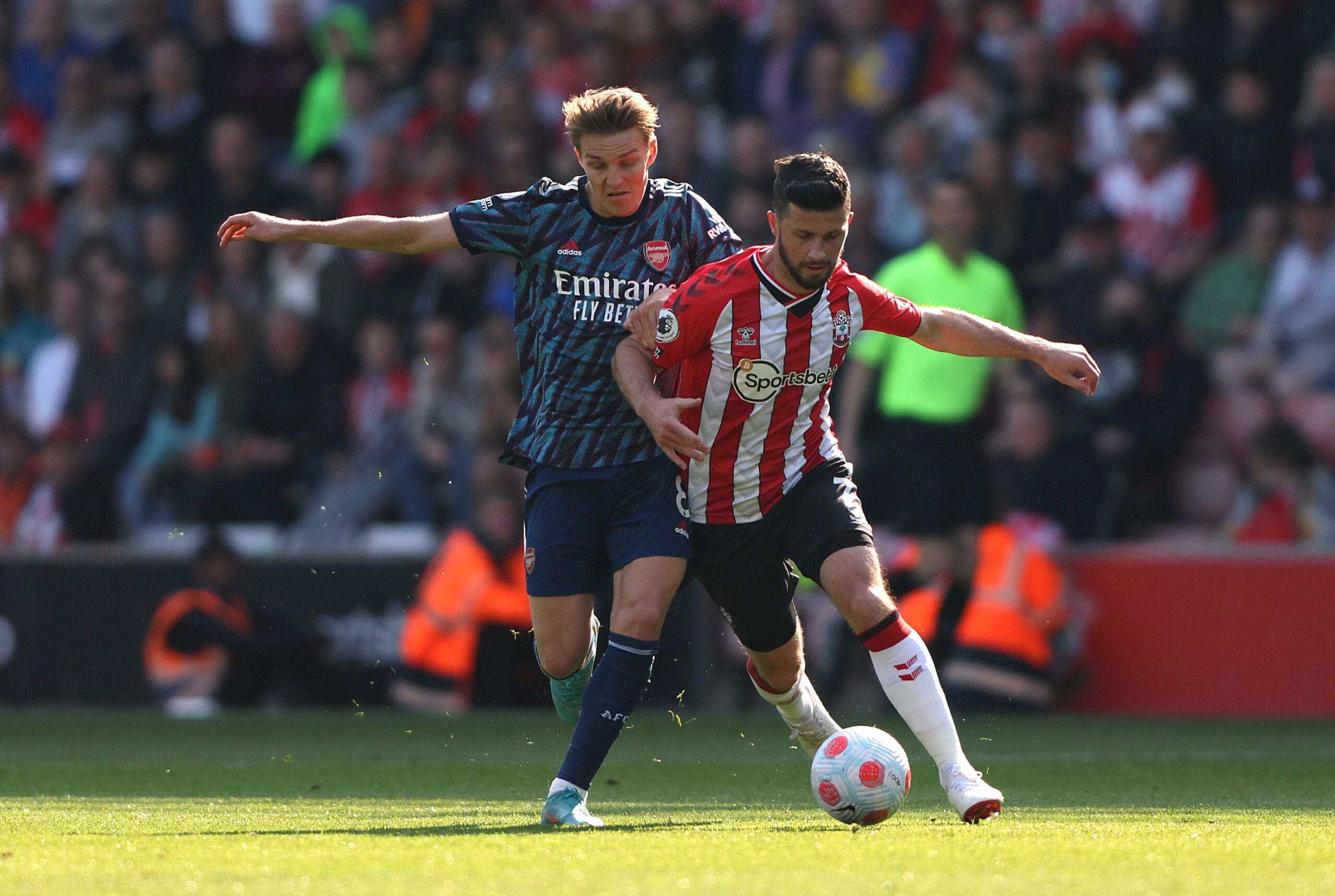 Soccer Football - Premier League - Southampton v Arsenal - St Mary's Stadium, Southampton, Britain - April 16, 2022 Arsenal's Martin Odegaard in action with Southampton's Shane Long REUTERS/Ian Walton EDITORIAL USE ONLY. No use with unauthorized audio, video, data, fixture lists, club/league logos or 'live' services. Online in-match use limited to 75 images, no video emulation. No use in betting, games or single club /league/player publications.  Please contact your account representative for fu