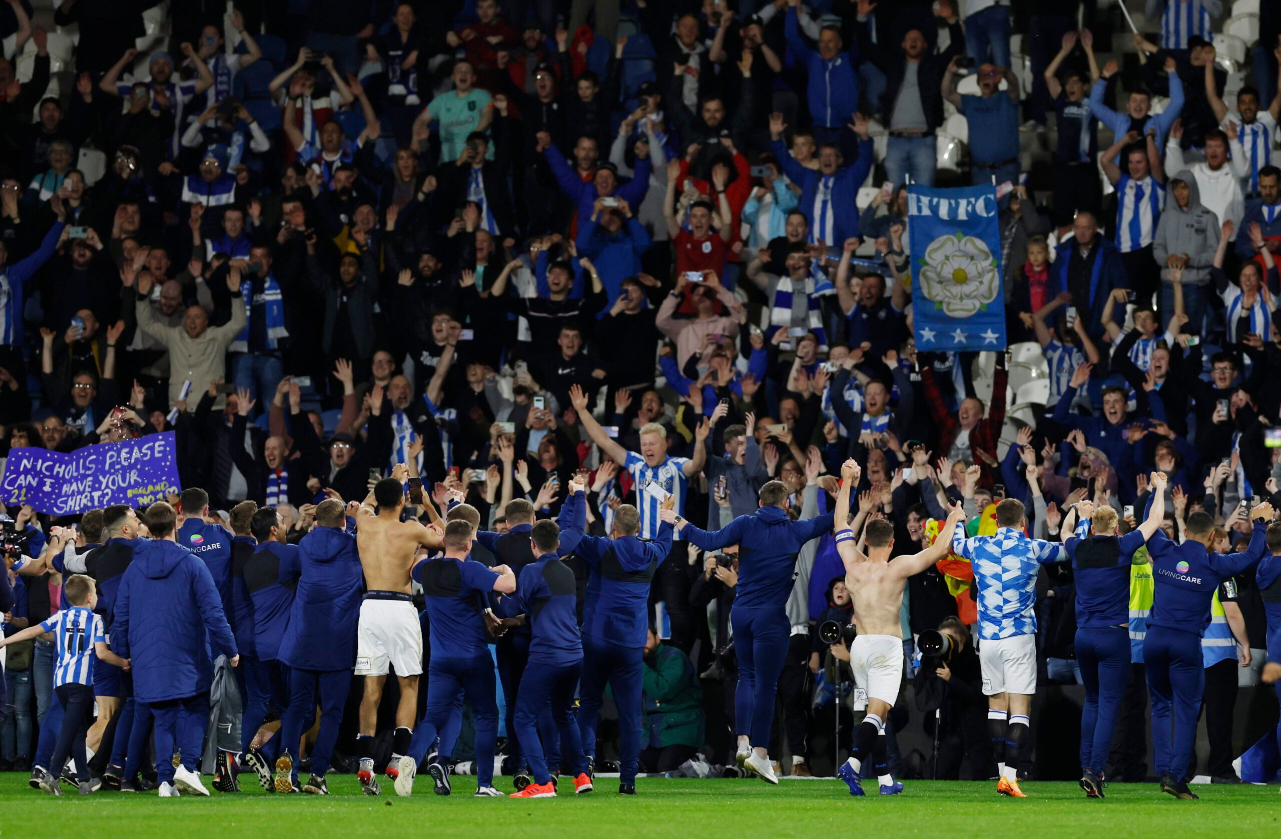 Soccer Football - Championship - Play-Offs Second Leg - Huddersfield Town v Luton Town - John Smith's Stadium, Huddersfield, Britain - May 16, 2022 Huddersfield Town players celebrate with fans after reaching the Championship Play-Off Final Action Images via Reuters/Jason Cairnduff