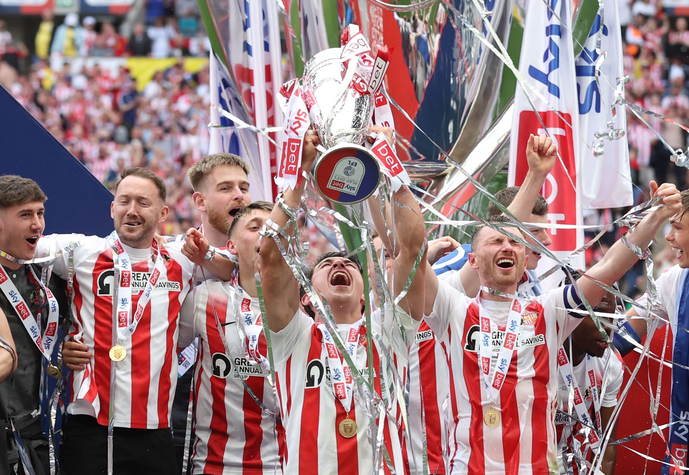 Soccer Football - League One Play-Off Final - Sunderland v Wycombe Wanderers - Wembley Stadium, London, Britain - May 21, 2022  Sunderland's Luke O'Nien celebrates with the trophy and teammates after winning the League One Play-Off Action Images/Matthew Childs EDITORIAL USE ONLY. No use with unauthorized audio, video, data, fixture lists, club/league logos or 'live' services. Online in-match use limited to 75 images, no video emulation. No use in betting, games or single club /league/player publ