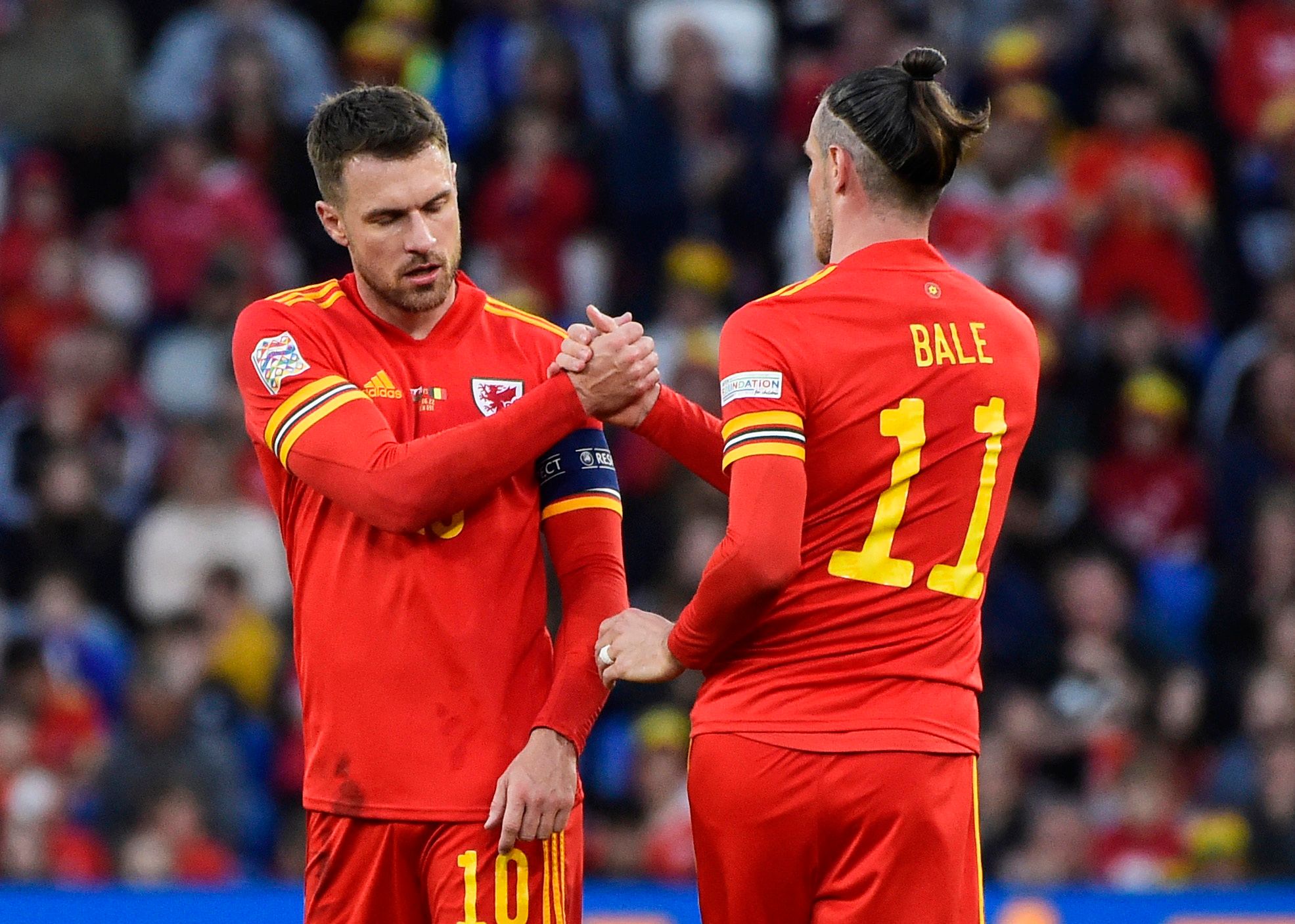 Soccer Football - UEFA Nations League - Group D - Wales v Belgium - Cardiff City Stadium, Cardiff, Wales, Britain - June 11, 2022 Wales' Gareth Bale shakes hands with Aaron Ramsey REUTERS/Rebecca Naden