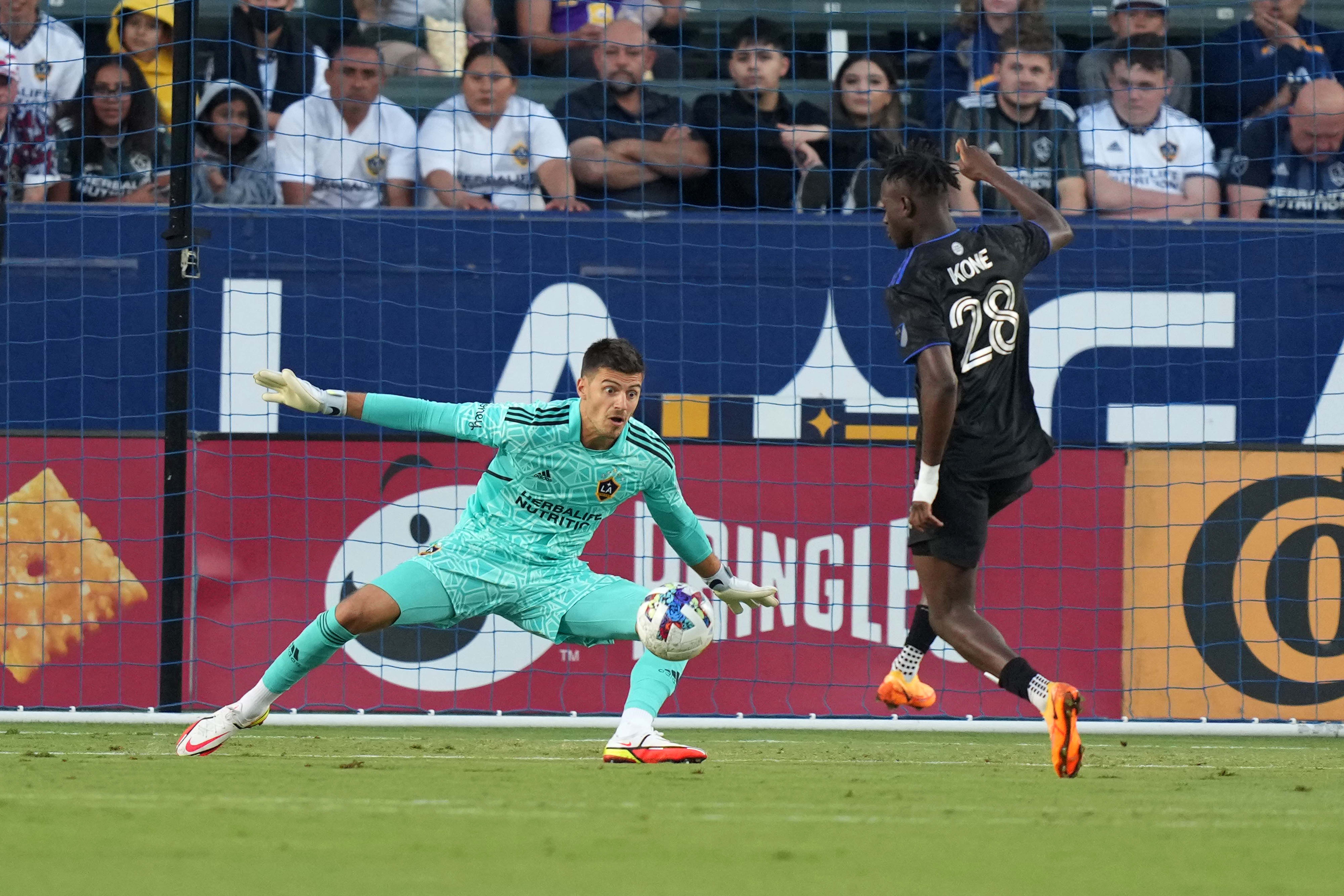 Jul 4, 2022; Carson, California, USA; LA Galaxy goalkeeper Jonathan Bond (1) defends the goal against CF Montreal midfielder Ismael Kone (28) in the first half at Dignity Health Sports Park. Mandatory Credit: Kirby Lee-USA TODAY Sports