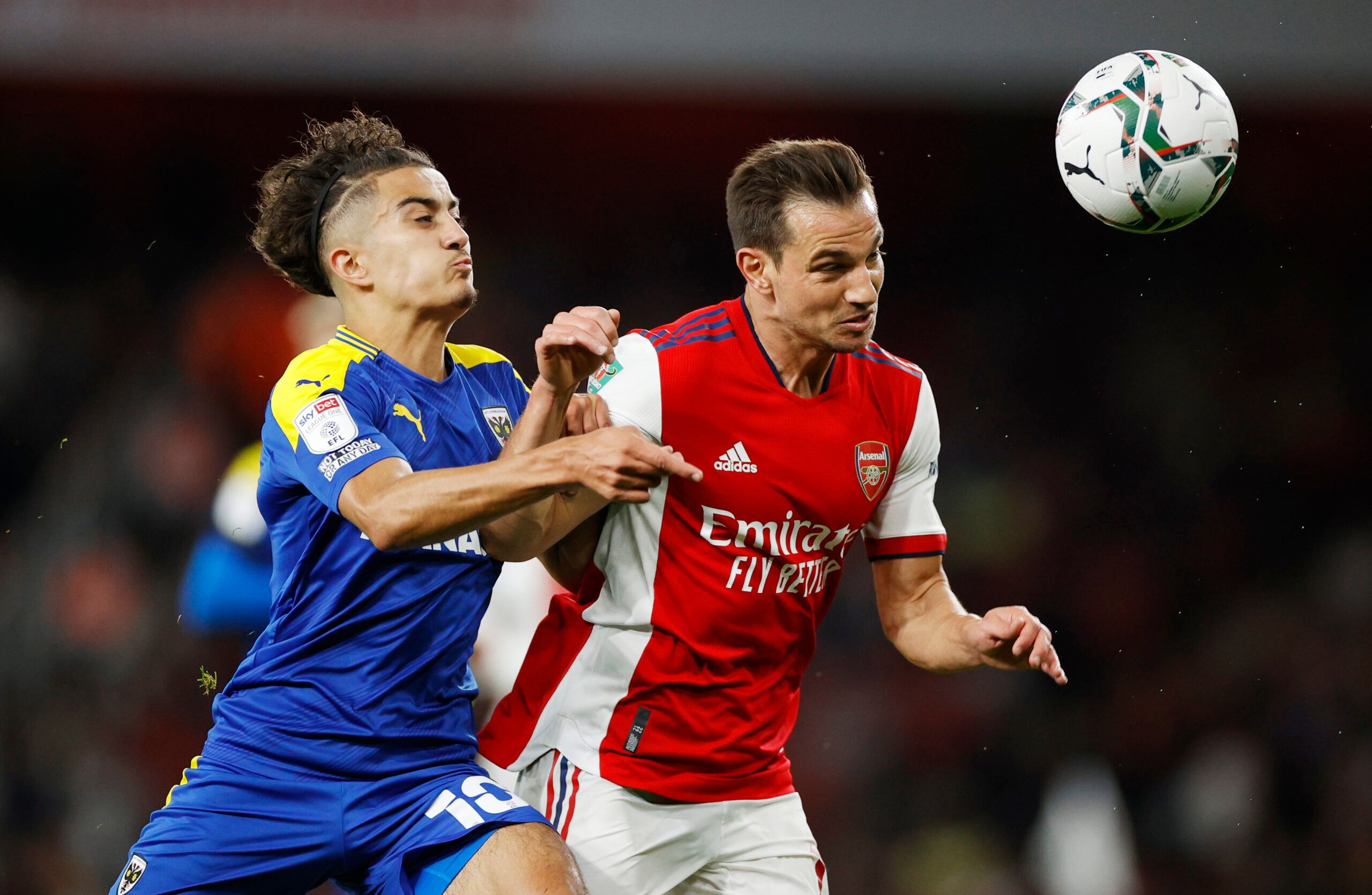 Soccer Football - Carabao Cup - Third Round - Arsenal v AFC Wimbledon - Emirates Stadium, London, Britain - September 22, 2021 AFC Wimbledon's Ayoub Assal in action with Arsenal's Cedric Soares Action Images via Reuters/John Sibley EDITORIAL USE ONLY. No use with unauthorized audio, video, data, fixture lists, club/league logos or 'live' services. Online in-match use limited to 75 images, no video emulation. No use in betting, games or single club /league/player publications.  Please contact you