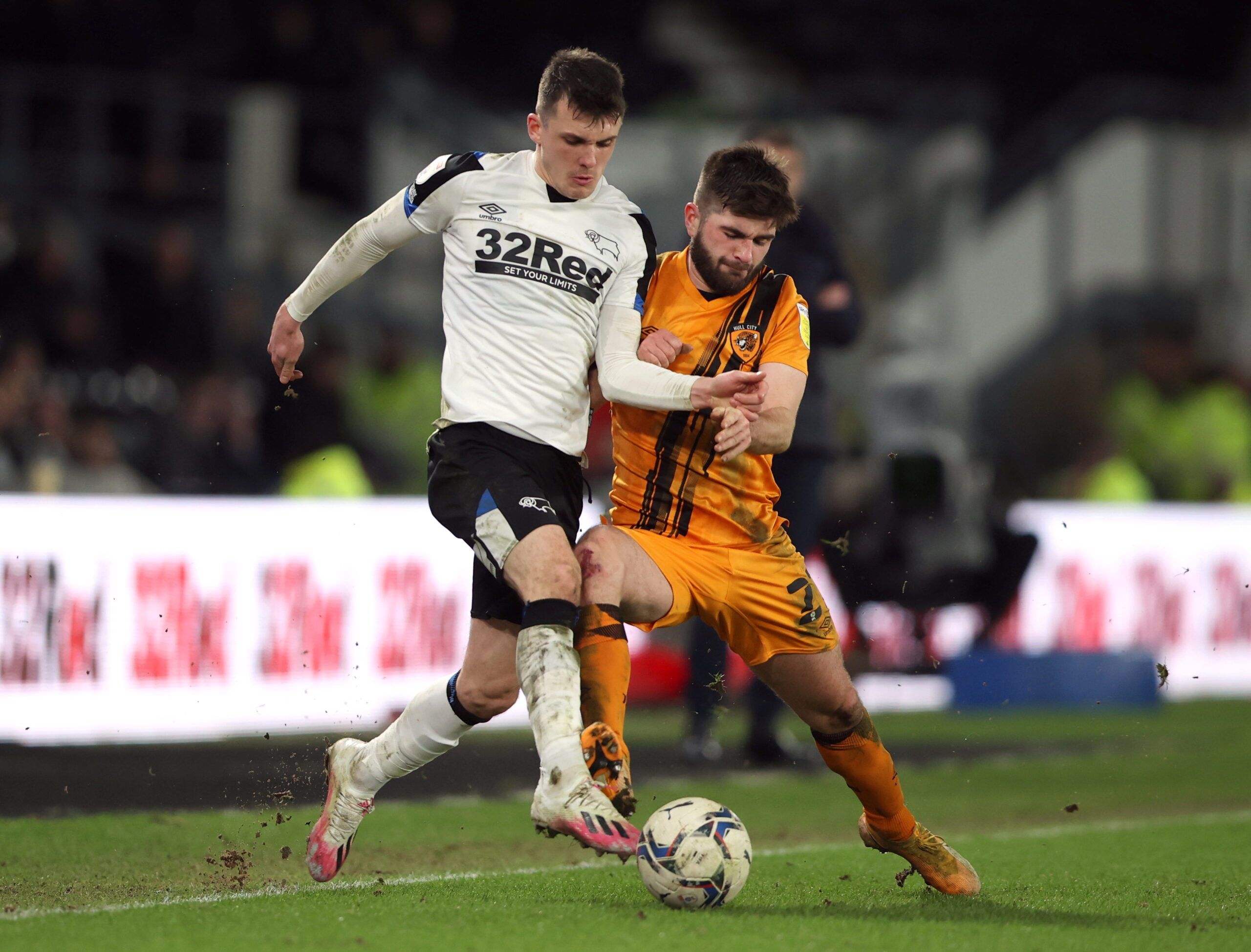 Soccer Football - Championship - Derby County v Hull City - Pride Park, Derby, Britain - February 8, 2022  Derby County's Jason Knight in action with Hull City's Brandon Fleming     Action Images/Molly Darlington  EDITORIAL USE ONLY. No use with unauthorized audio, video, data, fixture lists, club/league logos or 