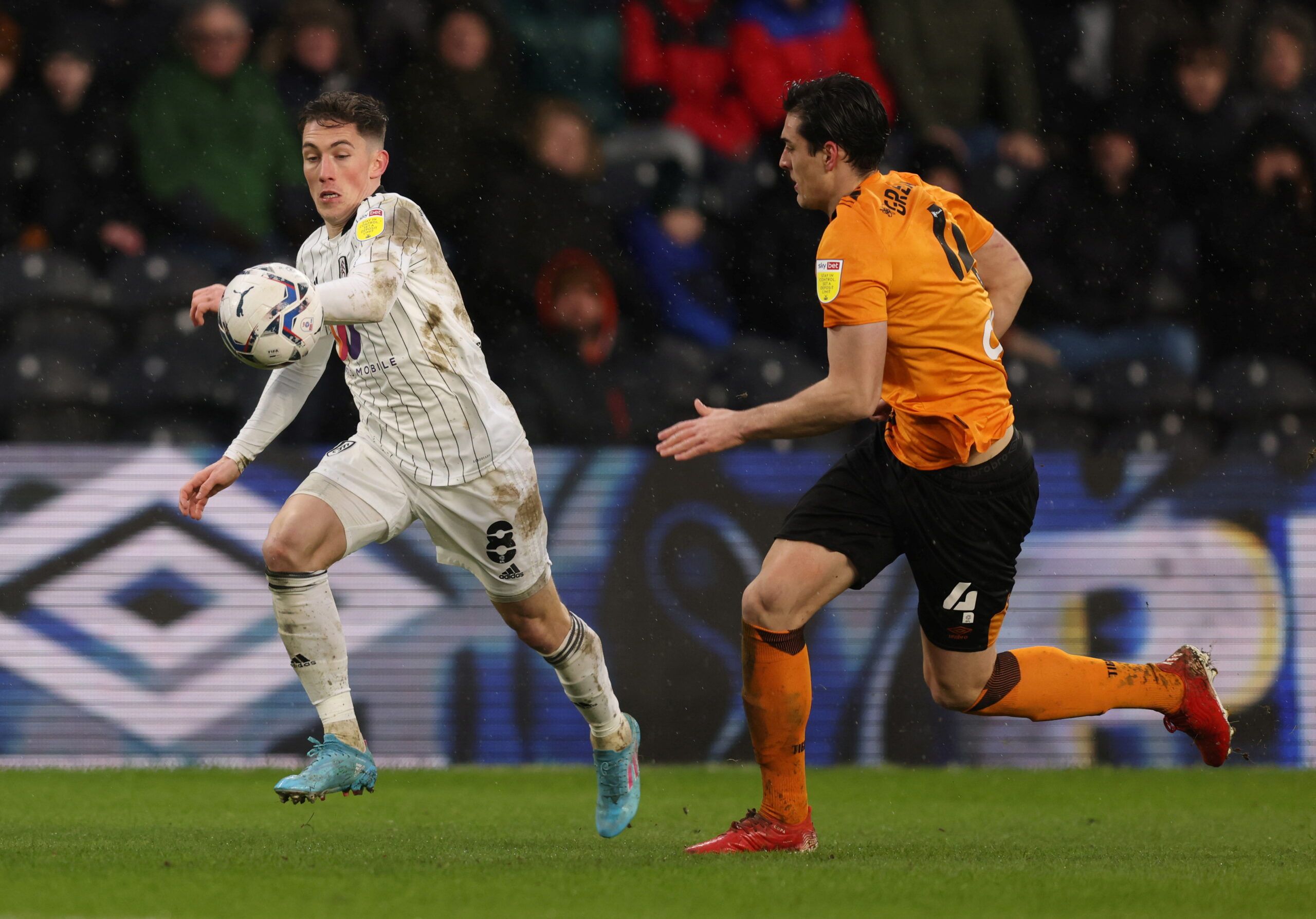 Soccer Football - Championship - Hull City v Fulham - KCOM Stadium, Hull, Britain - February 12, 2022  Fulham's Harry Wilson in action with Hull City's Jacob Greaves  Action Images/John Clifton  EDITORIAL USE ONLY. No use with unauthorized audio, video, data, fixture lists, club/league logos or 