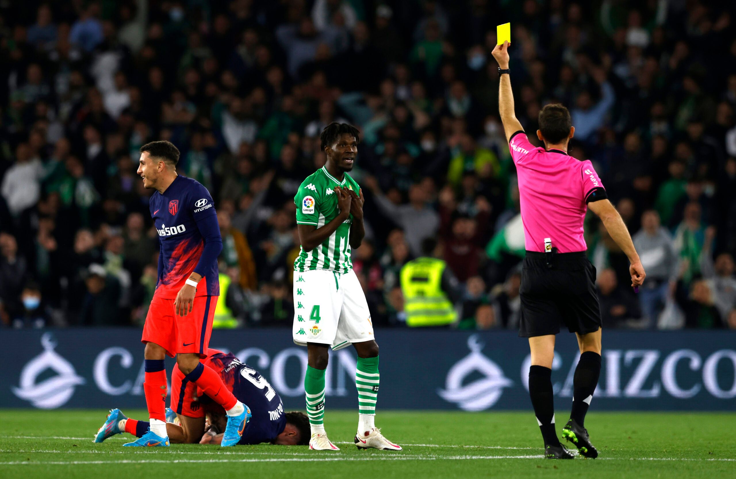 Soccer Football - LaLiga - Real Betis v Atletico Madrid - Estadio Benito Villamarin, Seville, Spain - March 6, 2022 Real Betis' Paul Akouokou is shown a yellow card by referee Guillermo Cuadra REUTERS/Marcelo Del Pozo