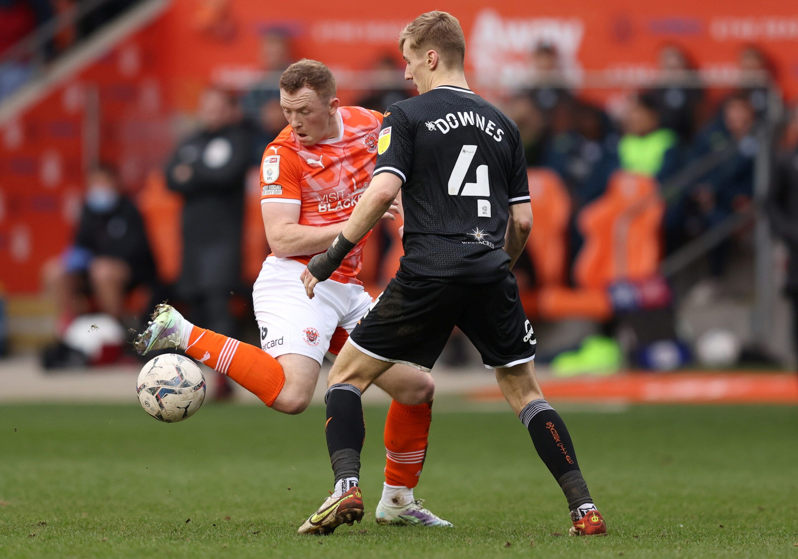 Soccer Football - Championship - Blackpool v Swansea City - Bloomfield Road, Blackpool , Britain - March 12, 2022  Blackpool's Shayne Lavery in action with Swansea City's Flynn Downes  Action Images/John Clifton  EDITORIAL USE ONLY. No use with unauthorized audio, video, data, fixture lists, club/league logos or 