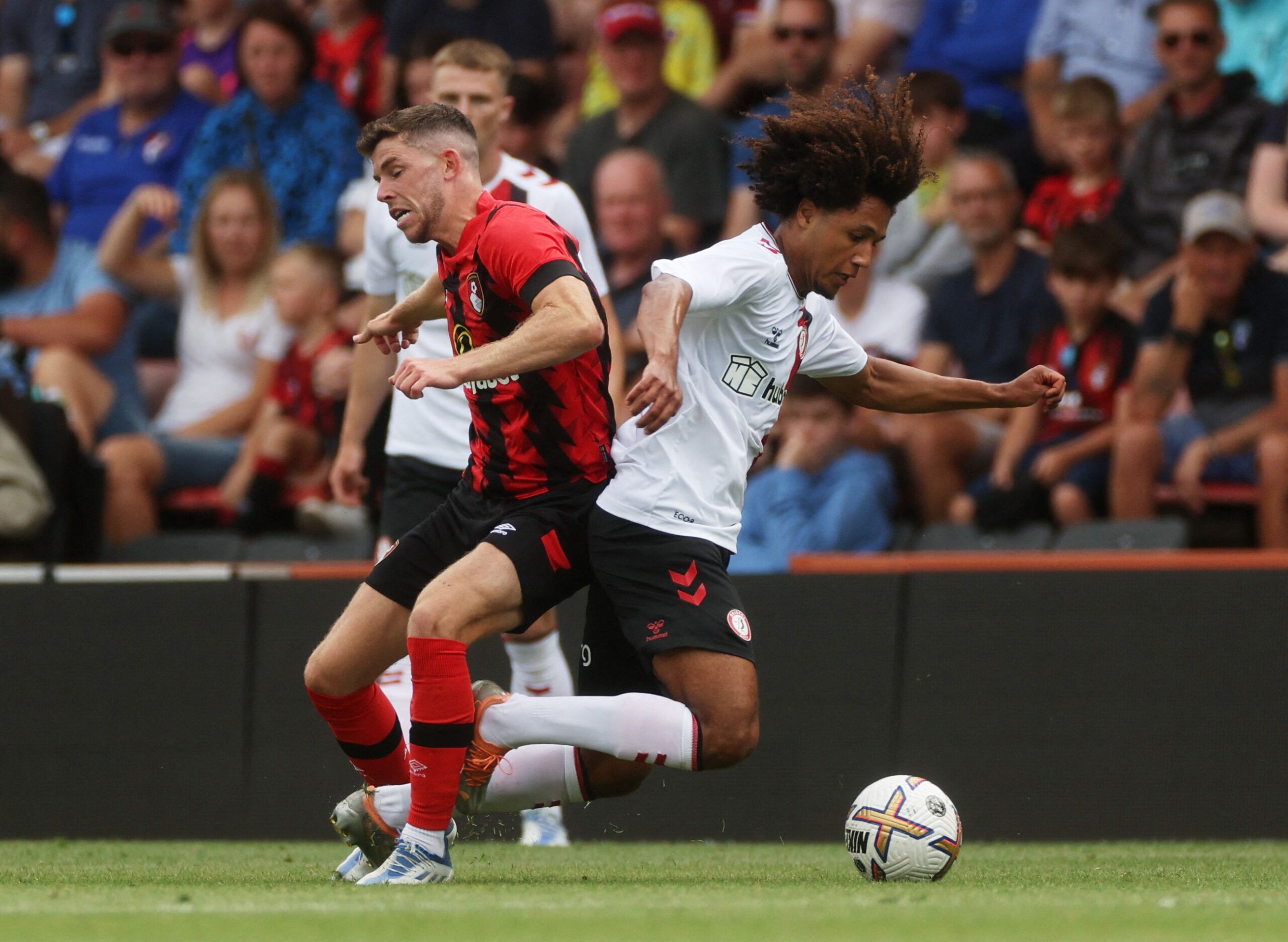 Soccer Football - Pre Season Friendly - AFC Bournemouth v Bristol City - Vitality Stadium, Bournemouth, Britain - July 23, 2022 AFC Bournemouth's Ryan Christie in action with Bristol City's Han-Noah Massengo Action Images via Reuters/Paul Childs