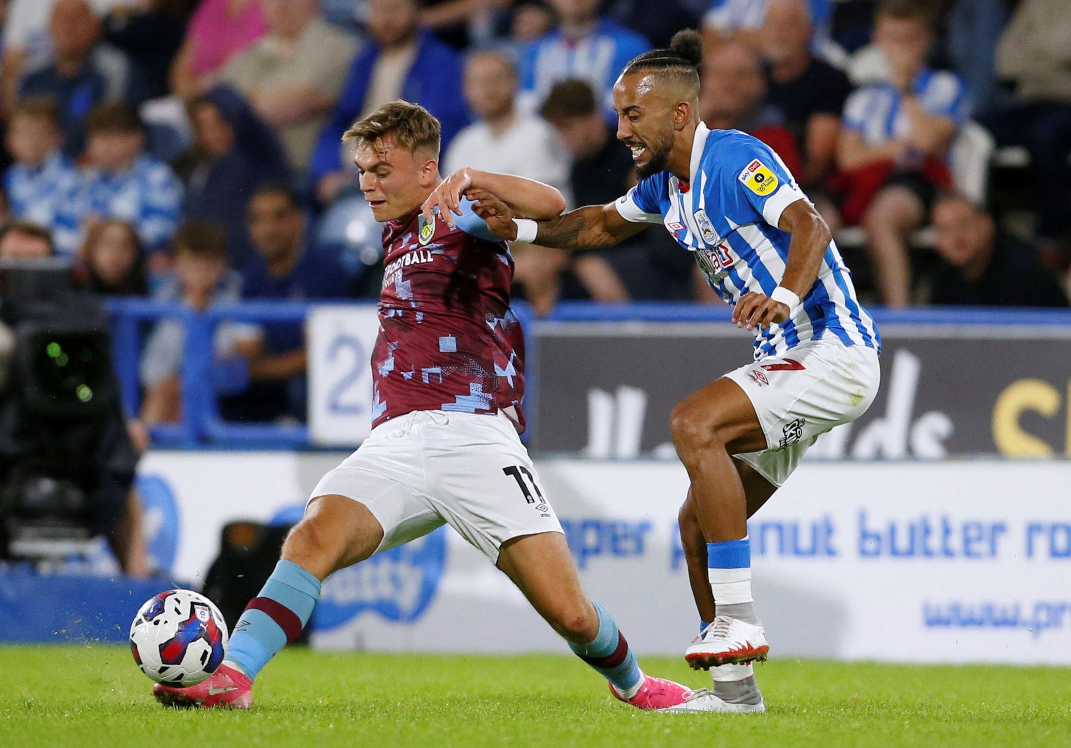 Soccer Football - Championship - Huddersfield Town v Burnley - John Smith's Stadium, Huddersfield, Britain - July 29, 2022 Burnley's Scott Twine in action with Huddersfield Town's Sorba Thomas  Action Images/Ed Sykes  EDITORIAL USE ONLY. No use with unauthorized audio, video, data, fixture lists, club/league logos or 