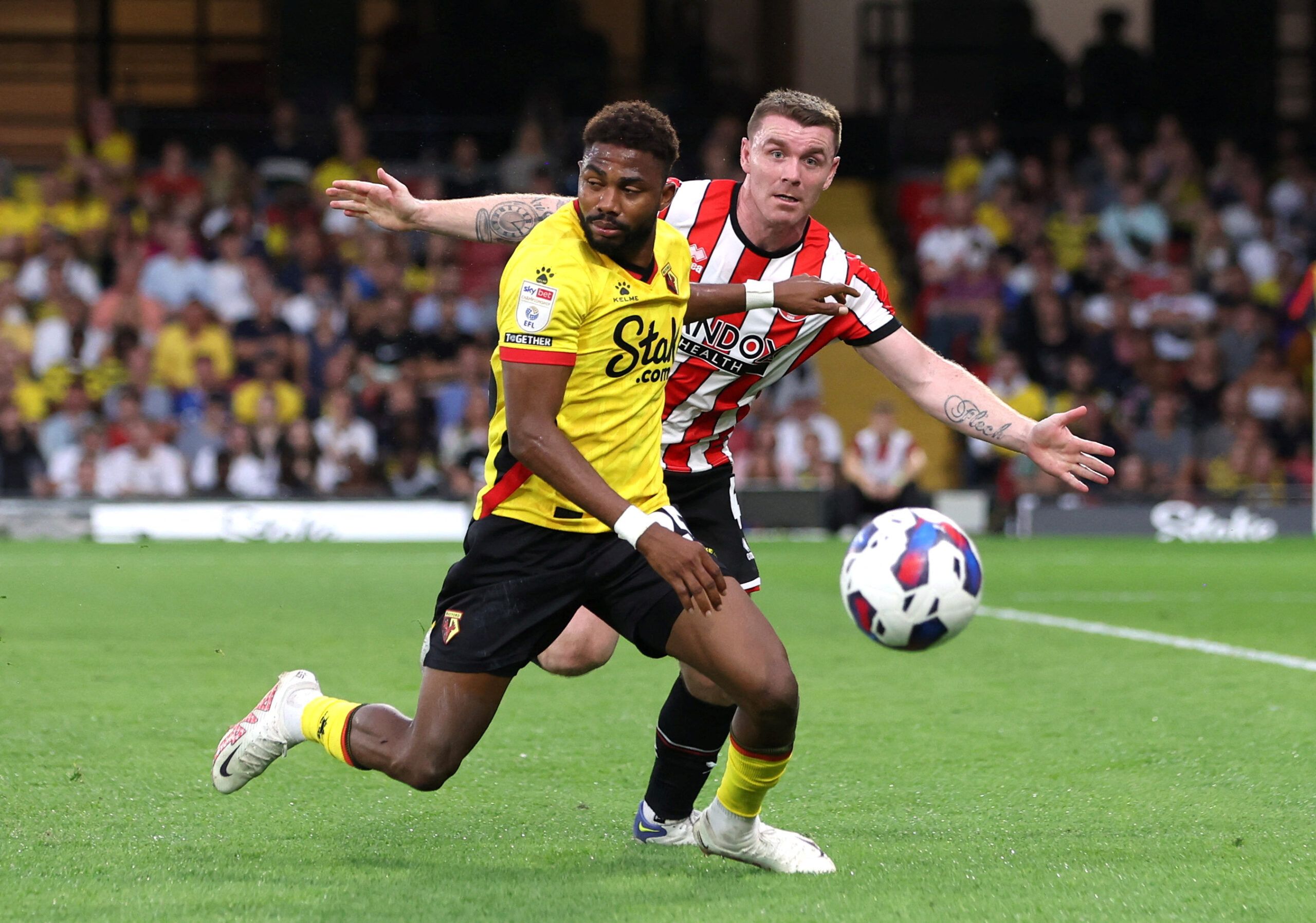 Soccer Football - Championship - Watford v Sheffield United - Vicarage Road, Watford, Britain - August 1, 2022 Watford's Emmanuel Dennis in action with Sheffield United's John Fleck  Action Images/Paul Childs  EDITORIAL USE ONLY. No use with unauthorized audio, video, data, fixture lists, club/league logos or 