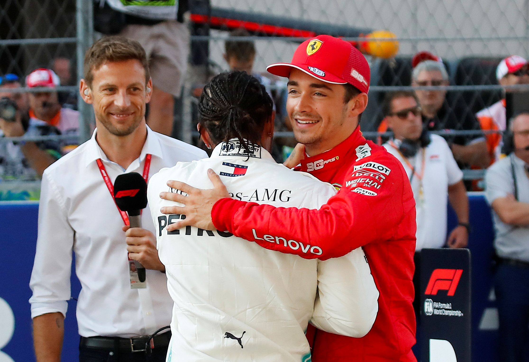 Formula One F1 - Russian Grand Prix - Sochi Autodrom, Sochi, Russia - September 28, 2019   After qualifying in pole position Ferrari's Charles Leclerc shakes hands with second placed Mercedes' Lewis Hamilton as Jenson Button looks on   REUTERS/Maxim Shemetov
