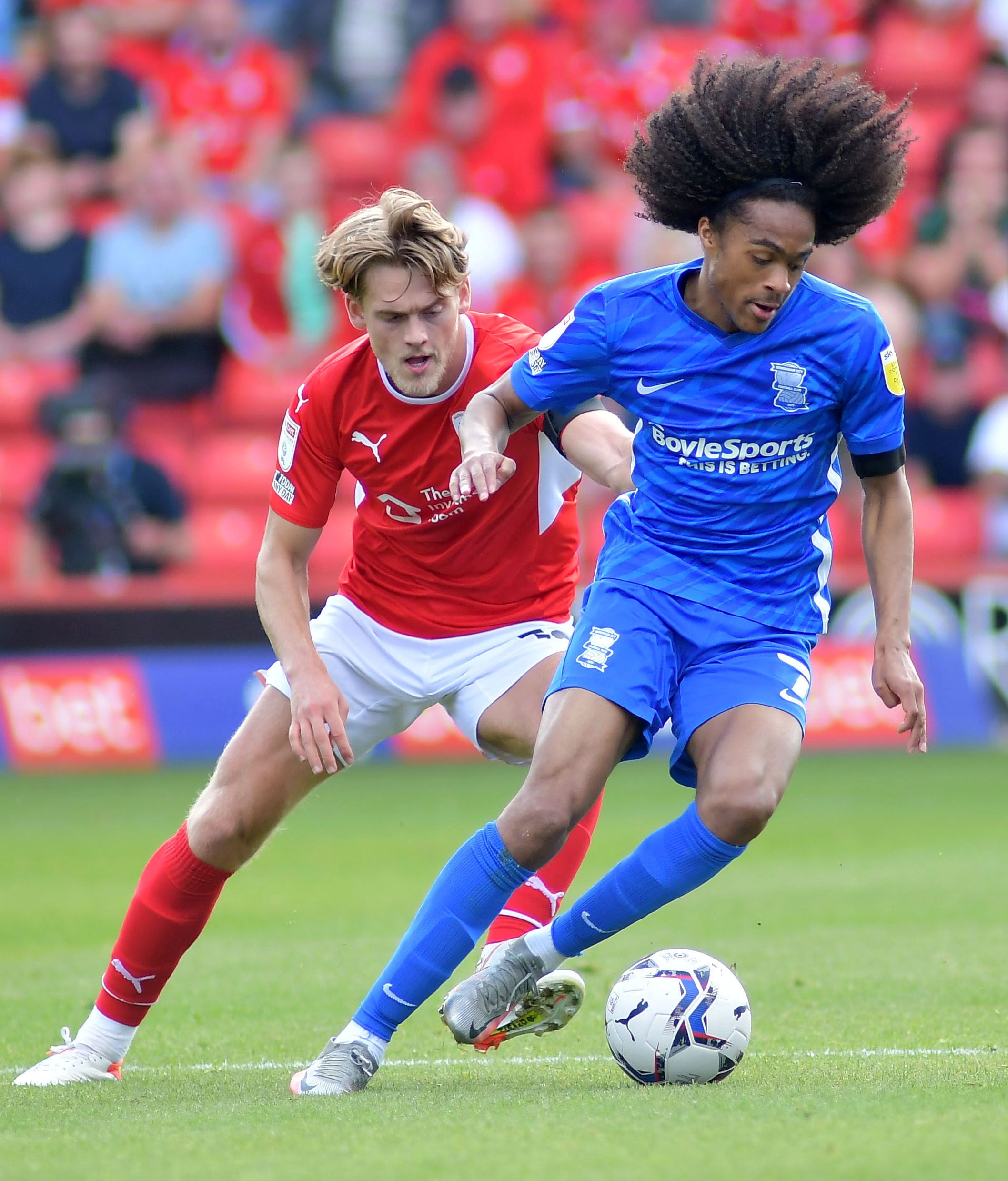 Soccer Football - Championship - Barnsley v Birmingham City - Oakwell, Barnsley, Britain - August 28, 2021  Birmingham City's Tahith Chong in action with Barnsley's Josh Benson  Action Images/Paul Burrows    EDITORIAL USE ONLY. No use with unauthorized audio, video, data, fixture lists, club/league logos or 