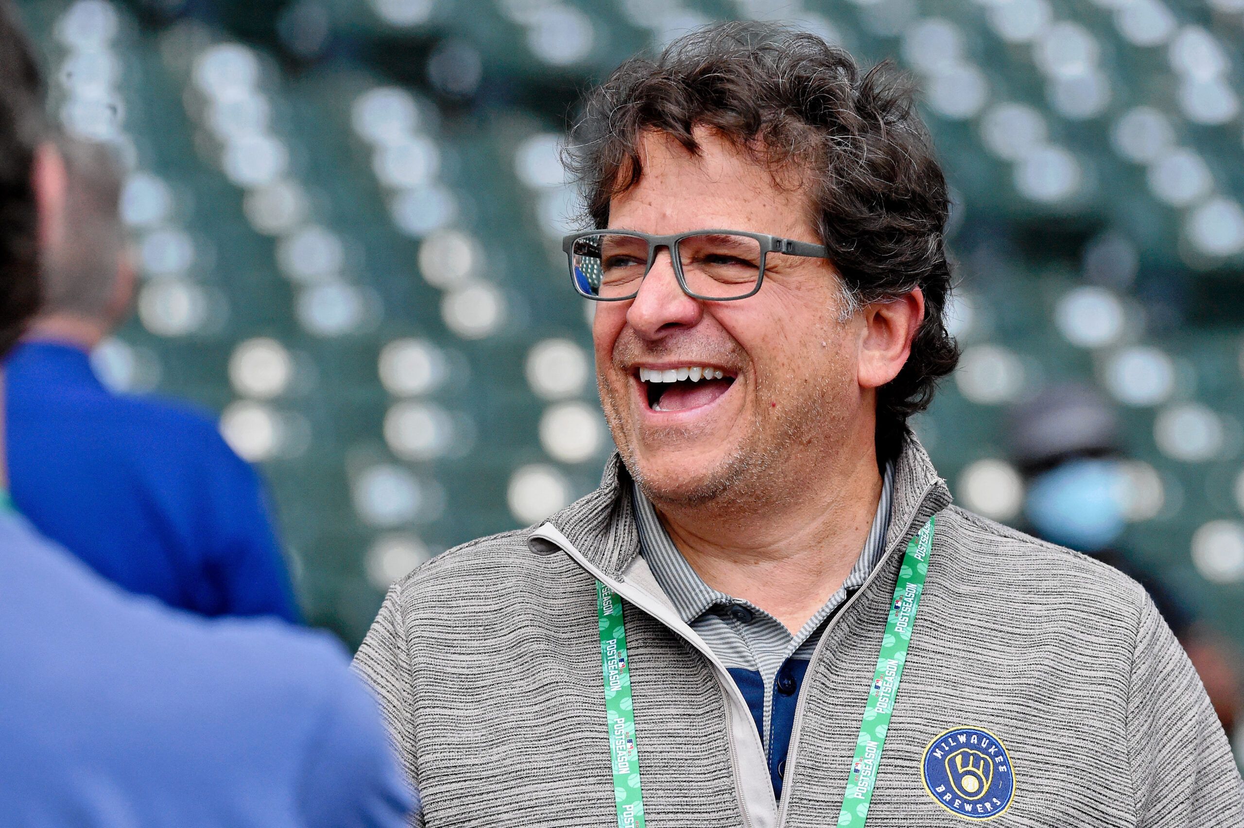 Oct 9, 2021; Milwaukee, Wisconsin, USA; Milwaukee Brewers chairman and principal owner Mark Attanasio laughs while talking on the field before game two of the 2021 NLDS at American Family Field. Mandatory Credit: Michael McLoone-USA TODAY Sports