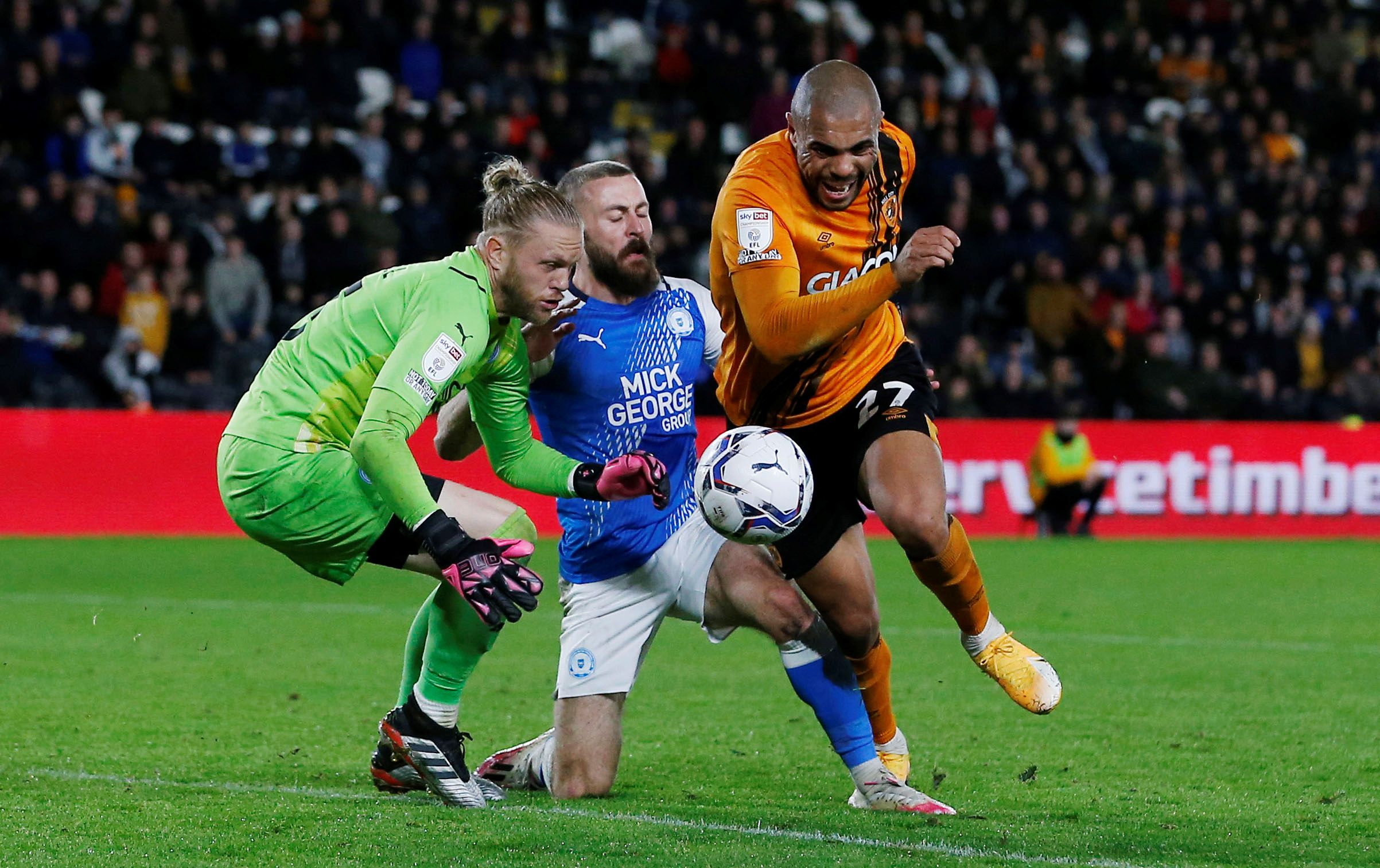 Soccer Football - Championship - Hull City v Peterborough United - KCOM Stadium, Hull, Britain - October 20, 2021  Hull City's Josh Magennis is denied a penalty after this challenge by Peterborough United's Dan Butler  Action Images/Craig Brough  EDITORIAL USE ONLY. No use with unauthorized audio, video, data, fixture lists, club/league logos or 