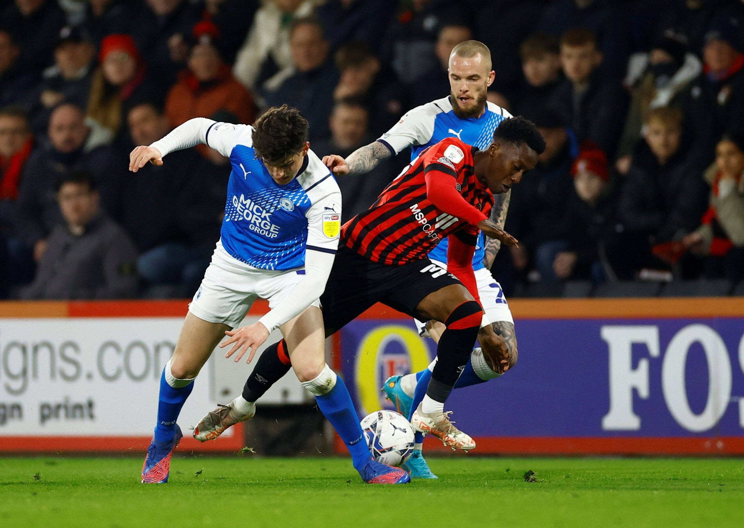 Soccer Football - Championship - AFC Bournemouth v Peterborough United - Vitality Stadium, Bournemouth, Britain - March 8, 2022   Bournemouth's Siriki Dembele in action with Peterborough United's Ronnie Edwards  Action Images/Andrew Boyers  EDITORIAL USE ONLY. No use with unauthorized audio, video, data, fixture lists, club/league logos or 