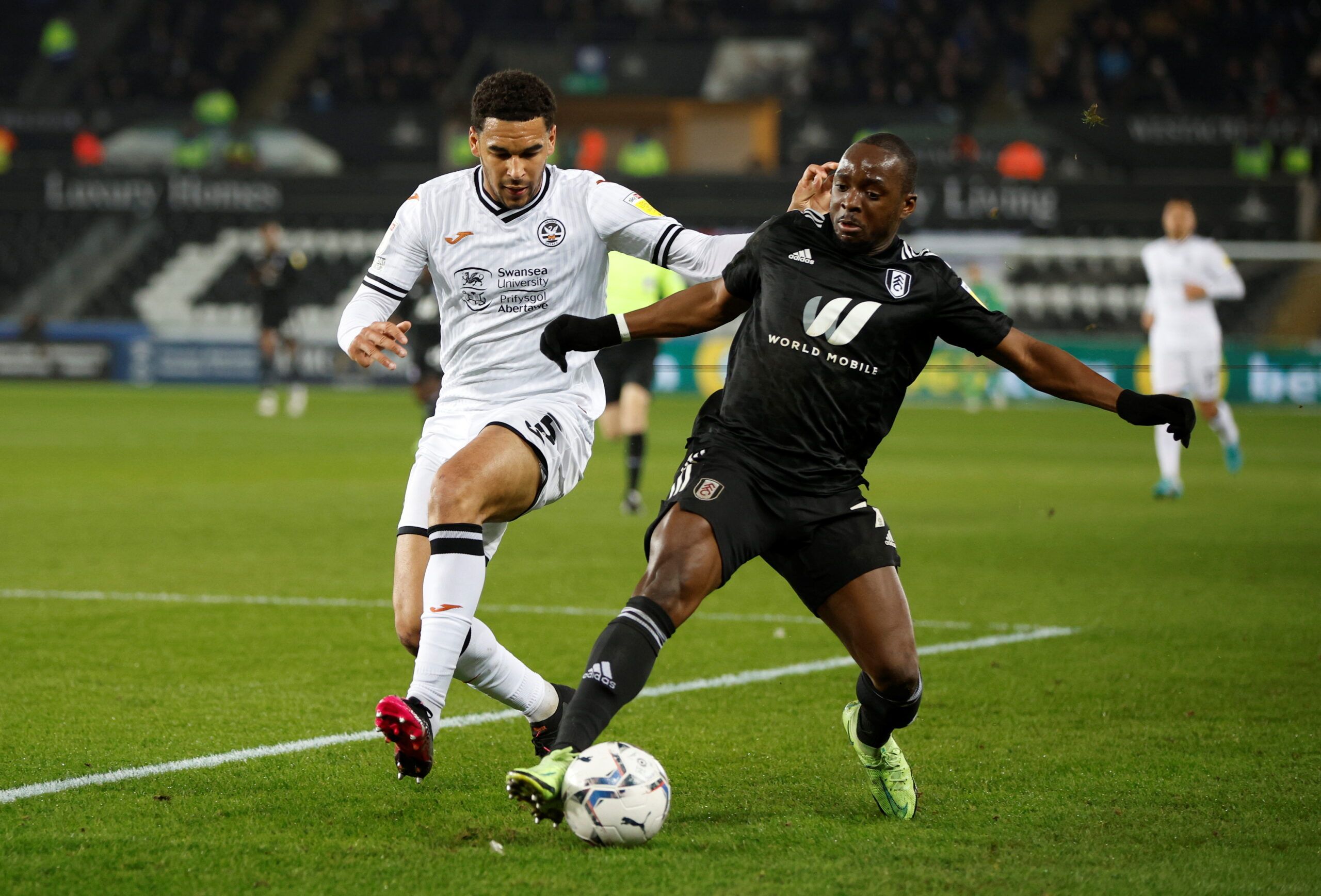 Soccer Football - Championship - Swansea City v Fulham - Swansea.com Stadium, Swansea, Britain - March 8, 2022  Swansea City's Ben Cabango in action with Fulham?s Needkens Kebano  Action Images/John Sibley  EDITORIAL USE ONLY. No use with unauthorized audio, video, data, fixture lists, club/league logos or 