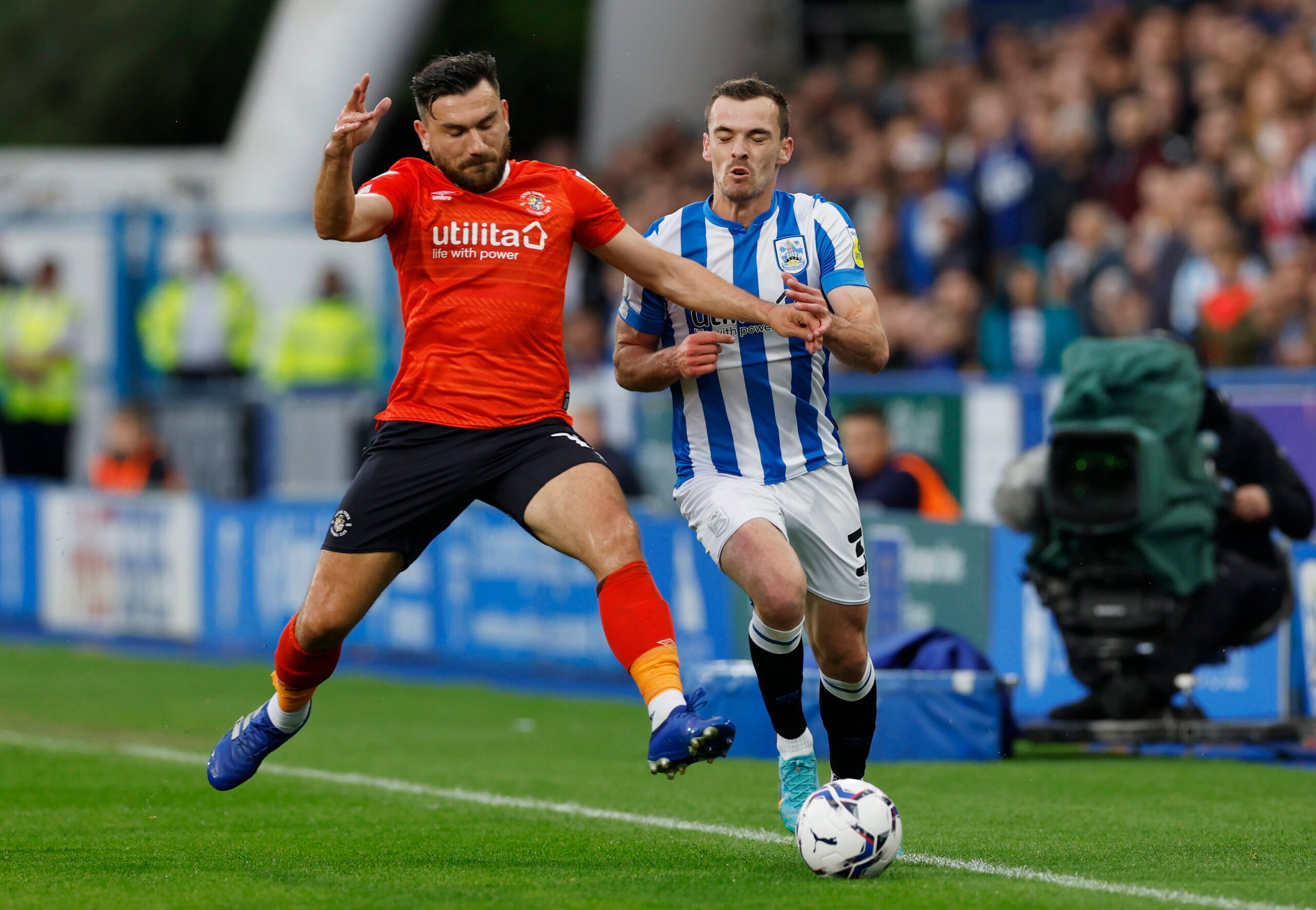 Soccer Football - Championship - Play-Offs Second Leg - Huddersfield Town v Luton Town - John Smith's Stadium, Huddersfield, Britain - May 16, 2022 Luton Town's Robert Snodgrass in action with Huddersfield Town's Harry Toffolo Action Images via Reuters/Jason Cairnduff