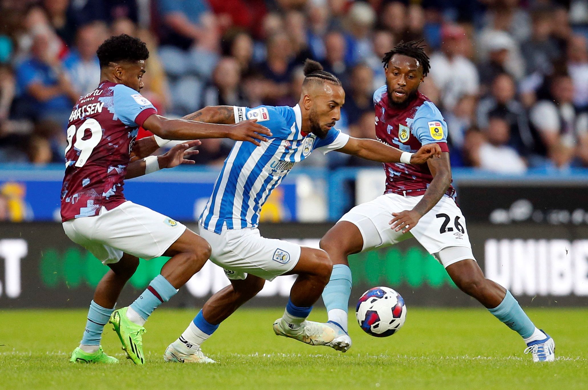 Soccer Football - Championship - Huddersfield Town v Burnley - John Smith's Stadium, Huddersfield, Britain - July 29, 2022  Huddersfield Town's Sorba Thomas in action with Burnley's Ian Maatsen and Samuel Bastien  Action Images/Ed Sykes  EDITORIAL USE ONLY. No use with unauthorized audio, video, data, fixture lists, club/league logos or "live" services. Online in-match use limited to 75 images, no video emulation. No use in betting, games or single club/league/player publications.  Please contac