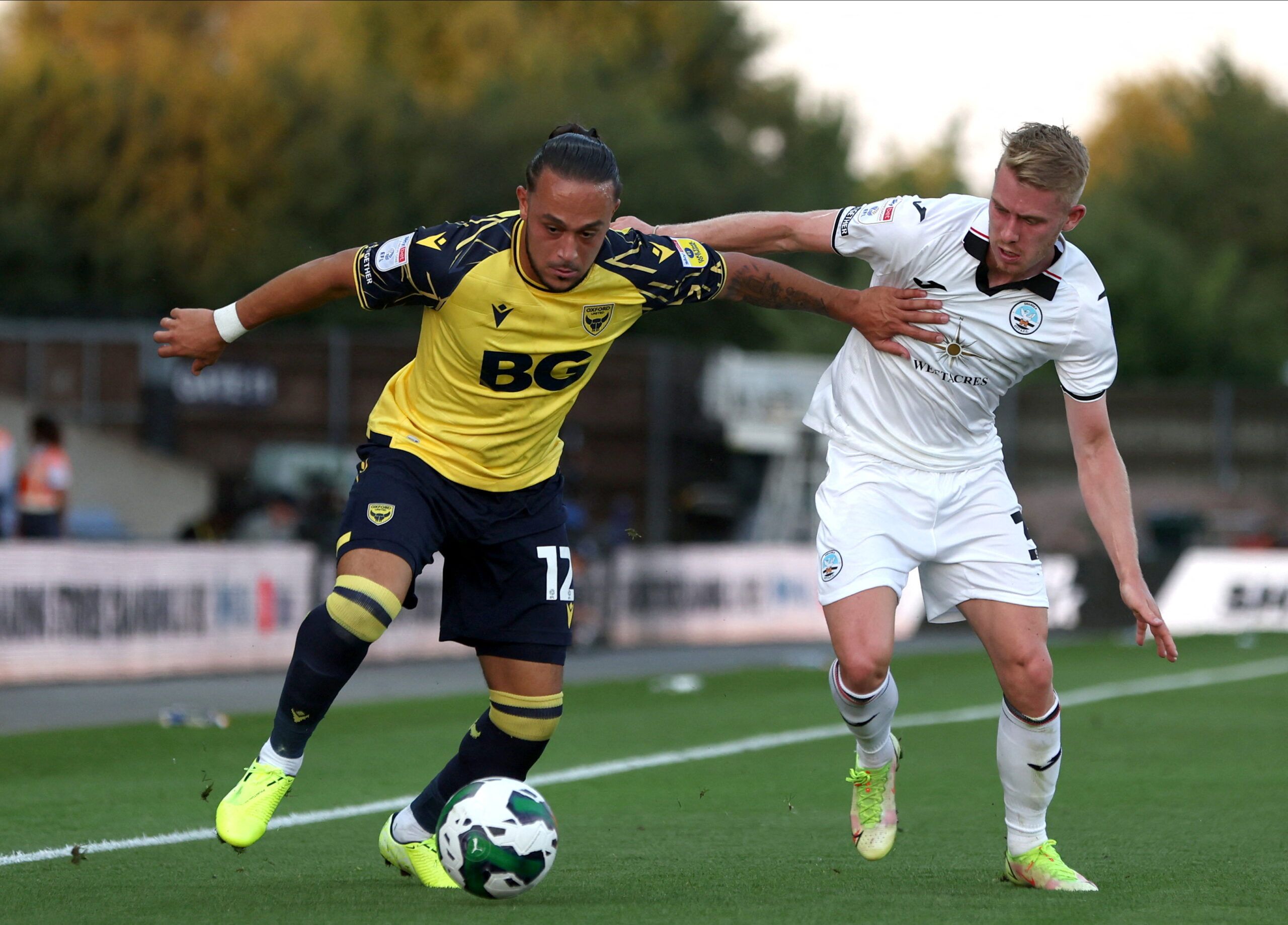 Soccer Football - Carabao Cup - Oxford United v Swansea City - Kassam Stadium, Oxford, Britain - August 9, 2022  Oxford United's Jodi Jones in action with Swansea City's Ollie Cooper Action Images/Paul Childs  EDITORIAL USE ONLY. No use with unauthorized audio, video, data, fixture lists, club/league logos or 