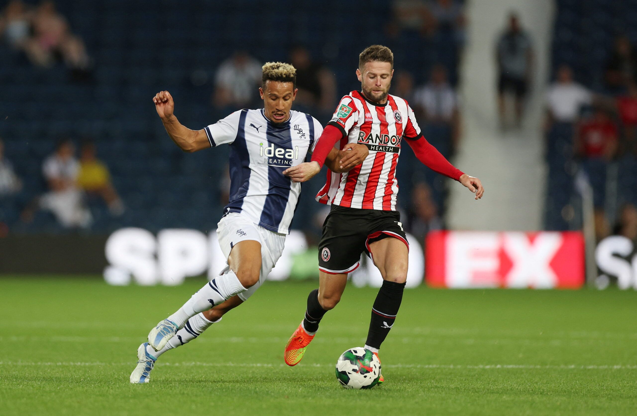 Soccer Football - Carabao Cup - West Bromwich Albion v Sheffield United - The Hawthorns, West Bromwich, Britain - August 11, 2022 West Bromwich Albion's Callum Robinson in action with Sheffield United's Oliver Norwood Action Images/Matthew Childs  EDITORIAL USE ONLY. No use with unauthorized audio, video, data, fixture lists, club/league logos or 