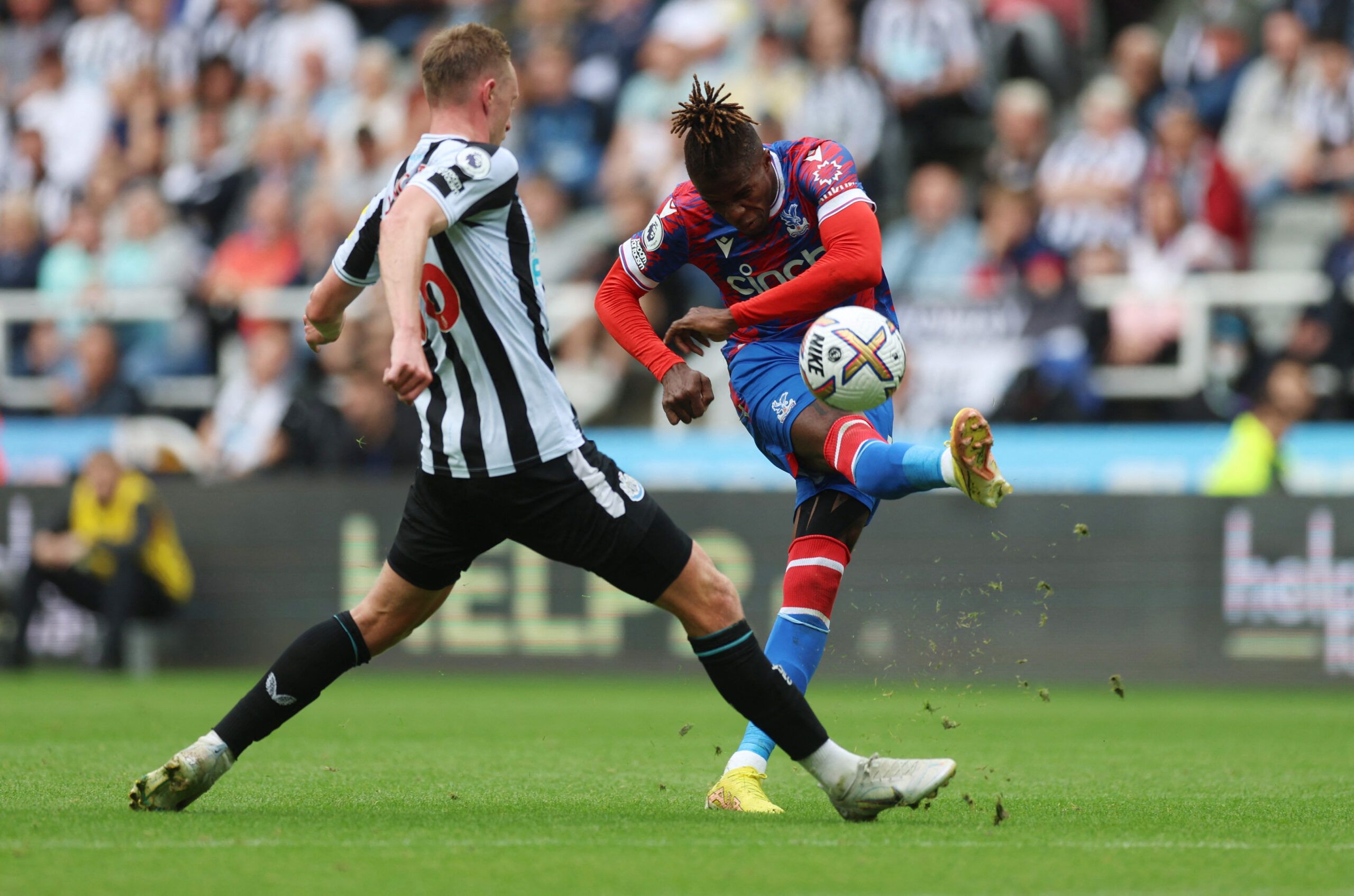 Soccer Football - Premier League - Newcastle United v Crystal Palace - St James' Park, Newcastle, Britain - September 3, 2022 Crystal Palace's Wilfried Zaha in action with Newcastle United's Sean Longstaff Action Images via Reuters/Lee Smith EDITORIAL USE ONLY. No use with unauthorized audio, video, data, fixture lists, club/league logos or 'live' services. Online in-match use limited to 75 images, no video emulation. No use in betting, games or single club /league/player publications.  Please c