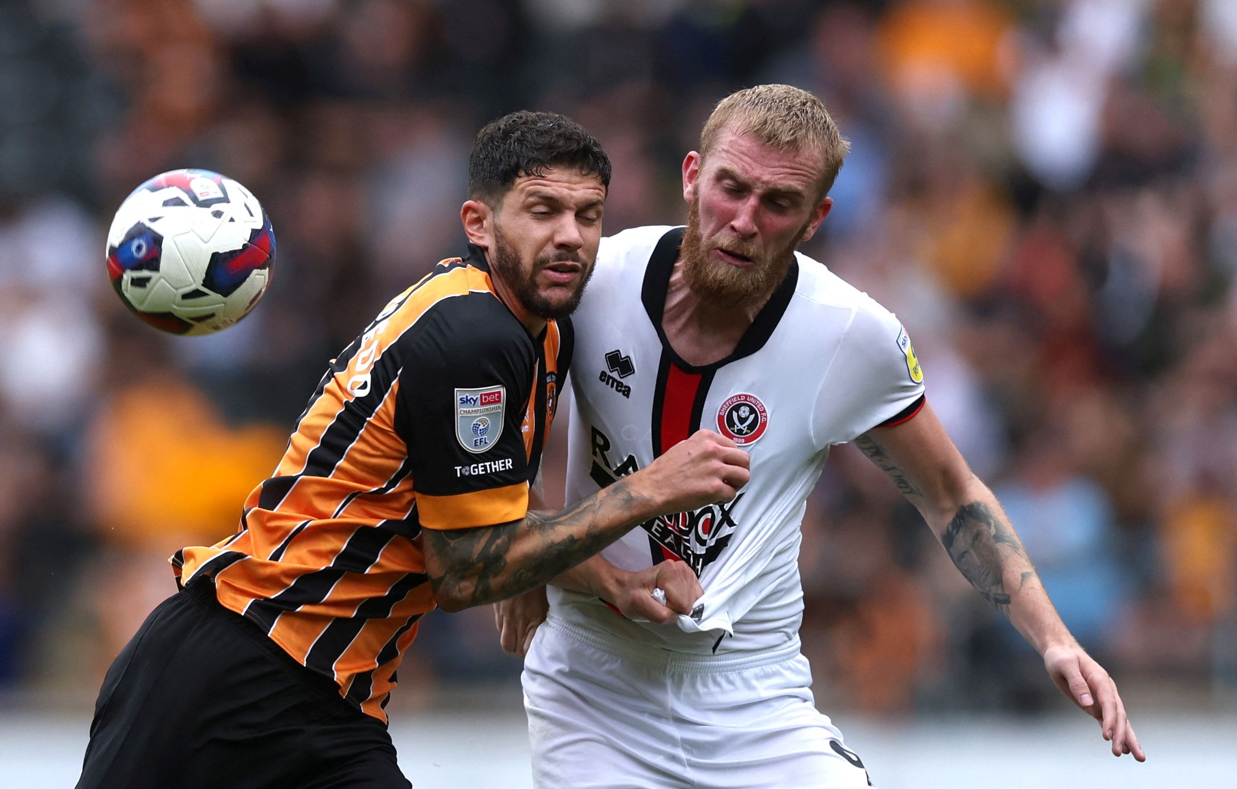 Soccer Football - Championship - Hull City v Sheffield United - MKM Stadium, Hull, Britain - September 4, 2022  Sheffield United's Oliver McBurnie in action with Hull City's Tobias Figueiredo   Action Images/Lee Smith  EDITORIAL USE ONLY. No use with unauthorized audio, video, data, fixture lists, club/league logos or 