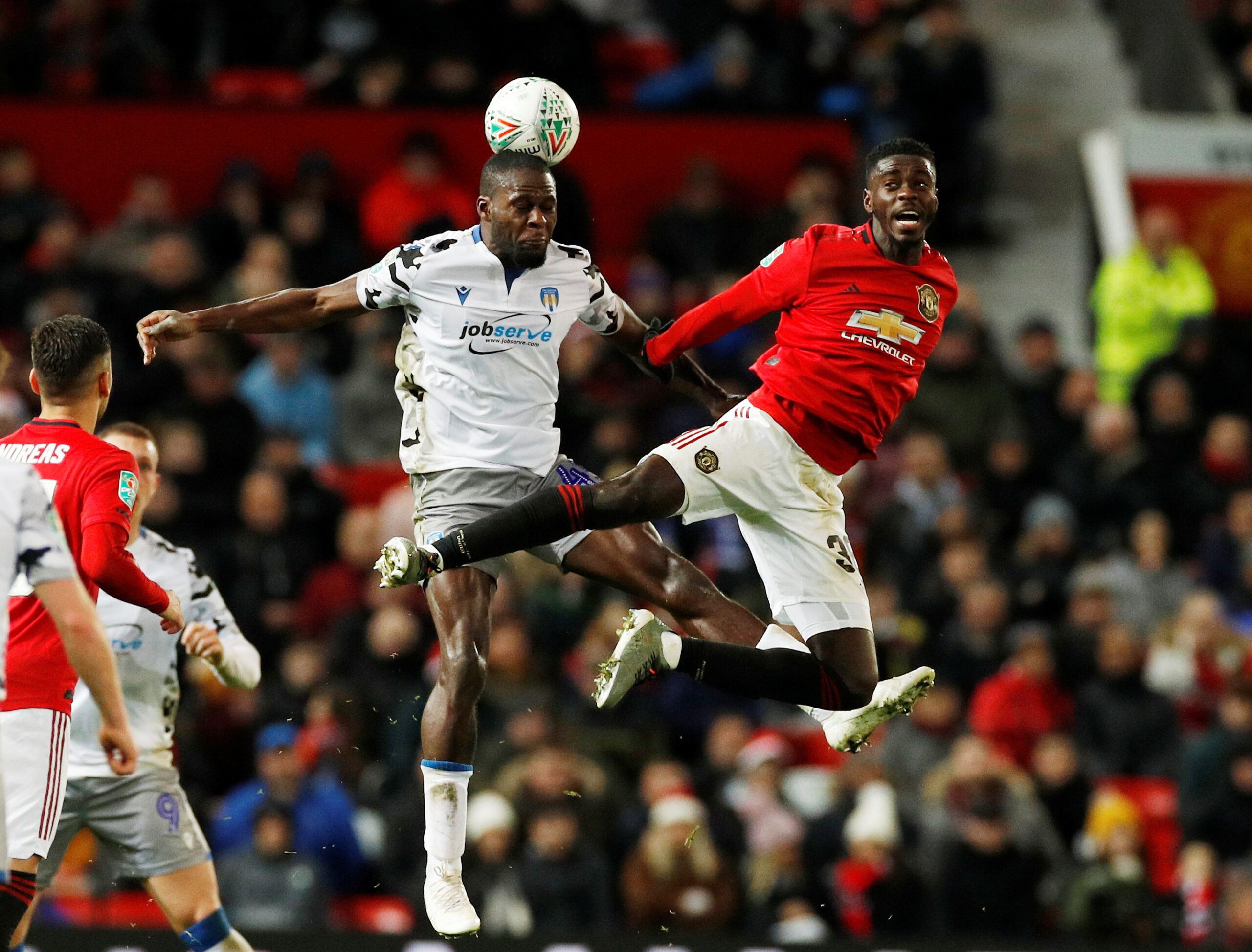 Soccer Football - Carabao Cup - Quarter Final - Manchester United v Colchester United - Old Trafford, Manchester, Britain - December 18, 2019  Colchester United's Frank Nouble in action with Manchester United's Axel Tuanzebe     REUTERS/Phil Noble  EDITORIAL USE ONLY. No use with unauthorized audio, video, data, fixture lists, club/league logos or 