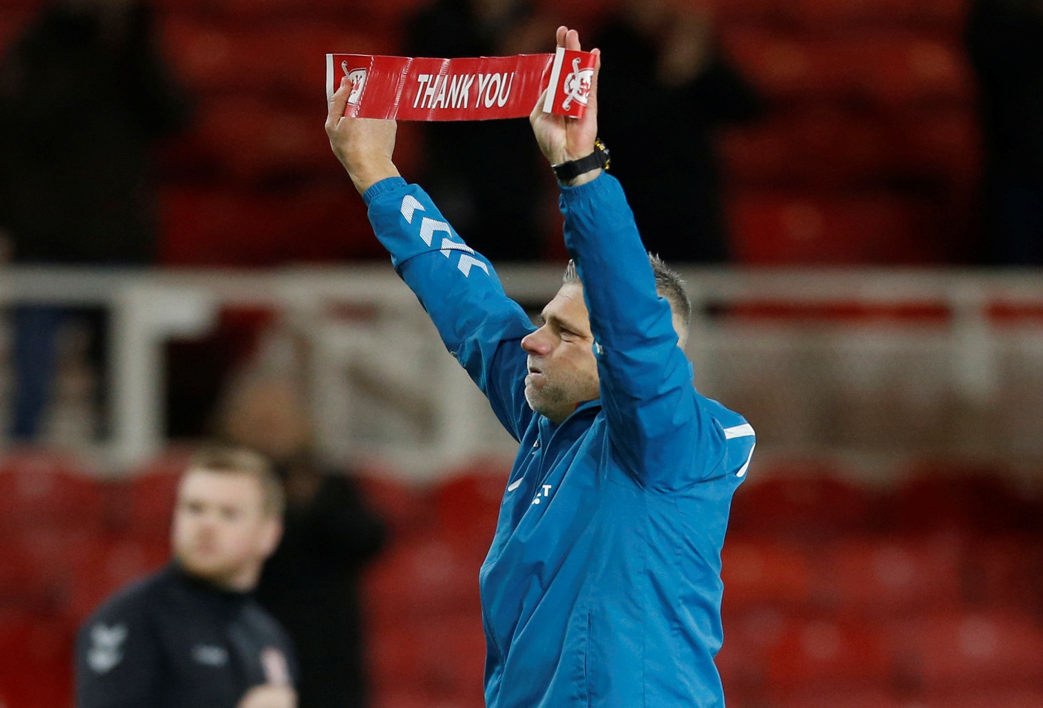 Soccer Football - Championship - Middlesbrough v Stoke City - Riverside Stadium, Middlesbrough, Britain - December 20, 2019  Middlesbrough coach Leo Percovich holds up a banner after the match  Action Images/Ed Sykes  EDITORIAL USE ONLY. No use with unauthorized audio, video, data, fixture lists, club/league logos or 