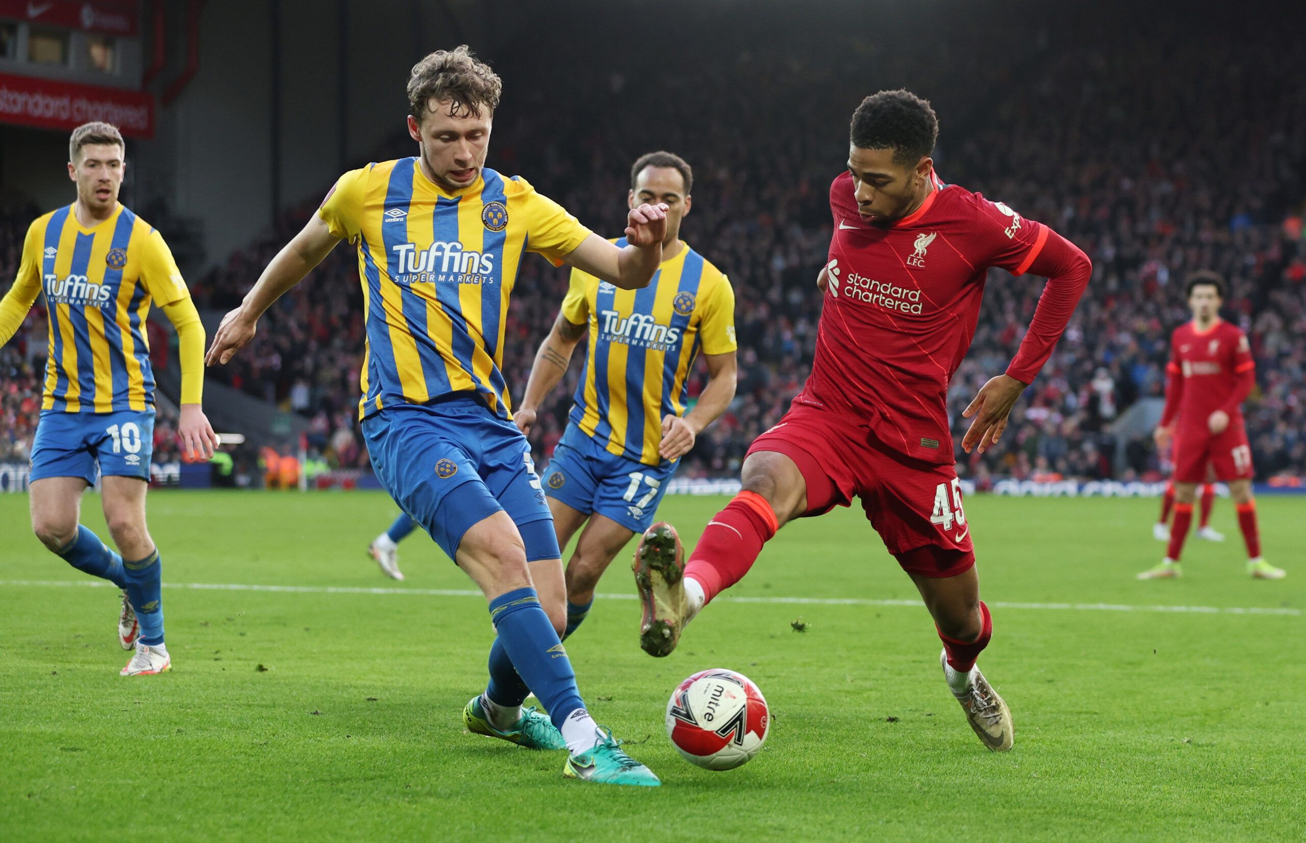 Soccer Football - FA Cup Third Round - Liverpool v Shrewsbury Town - Anfield, Liverpool, Britain - January 9, 2022 Shrewsbury Town's Luke Leahy in action with Liverpool's Elijah Dixon-Bonner REUTERS/Phil Noble