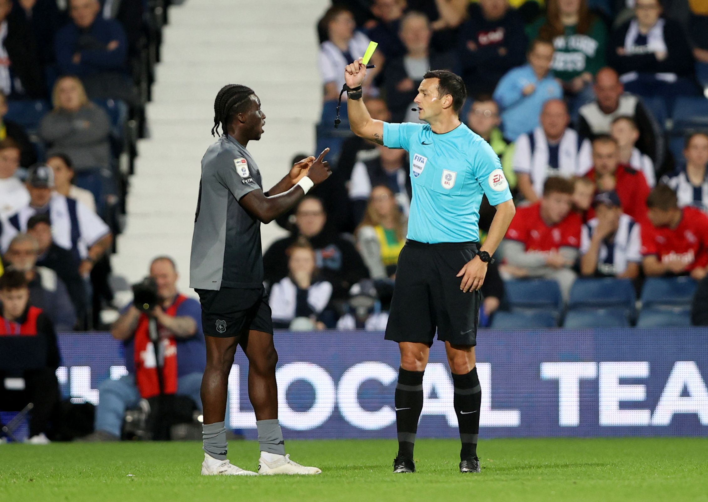 Soccer Football - Championship - West Bromwich Albion v Cardiff City - The Hawthorns, West Bromwich, Britain - August 17, 2022 Cardiff City's Sheyi Ojo is shown a yellow card by referee Action Images/Molly Darlington  EDITORIAL USE ONLY. No use with unauthorized audio, video, data, fixture lists, club/league logos or 