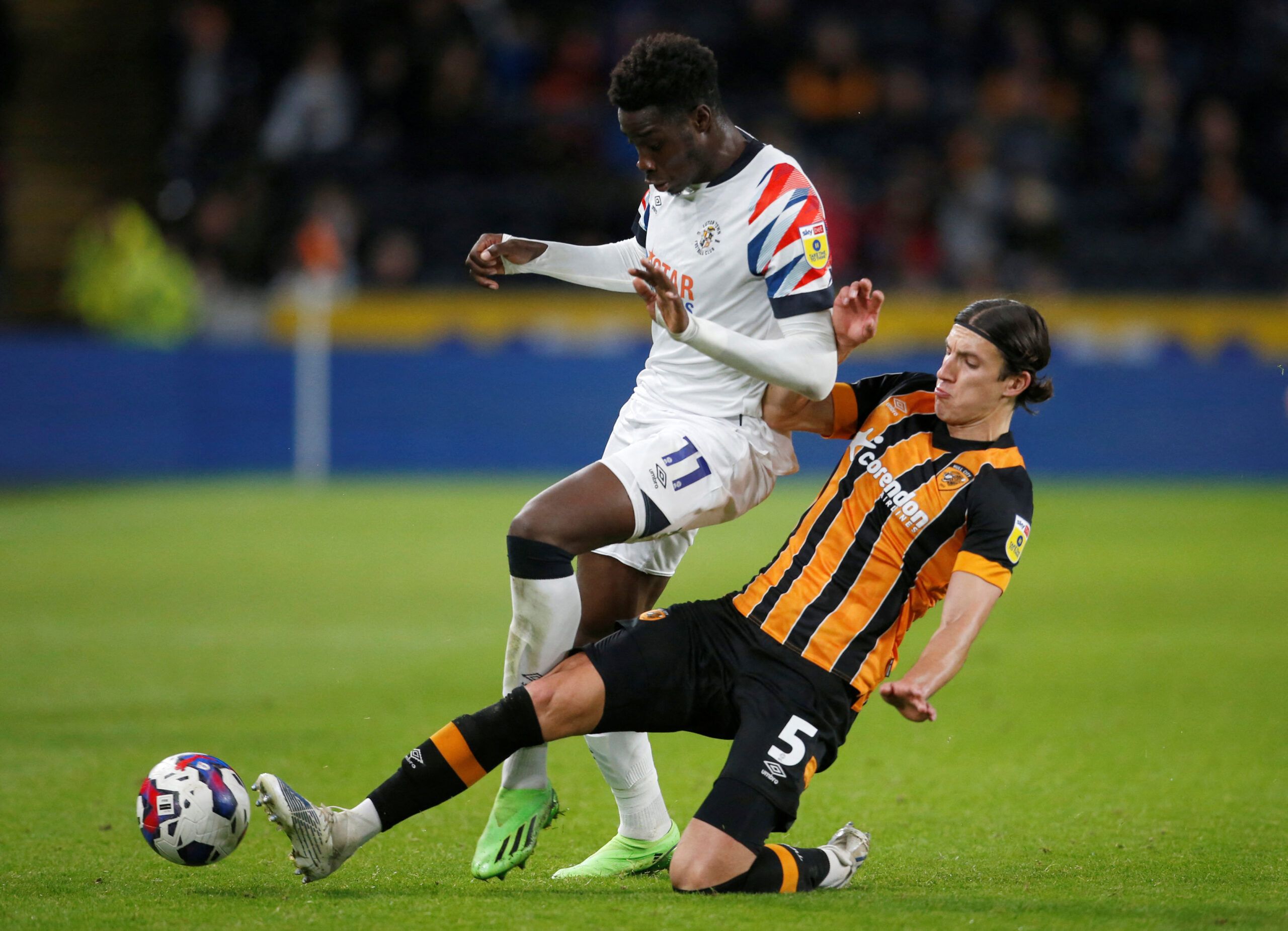 Soccer Football - Championship - Hull City v Luton Town - MKM Stadium, Hull, Britain - September 30, 2022 Luton Town's Elijah Adebayo and Hull City's Alfie Jones in action Action Images/Ed Sykes  EDITORIAL USE ONLY. No use with unauthorized audio, video, data, fixture lists, club/league logos or 