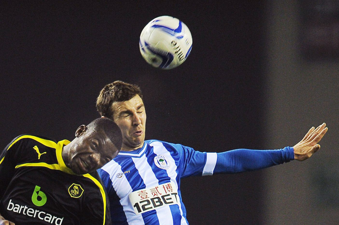 Football - Wigan Athletic v Sheffield Wednesday - Sky Bet Football League Championship - DW Stadium - 12/3/14 
Wigan Athletic's James McArthur (R) and Sheffield Wednesday's Adedeji Oshilaja in action 
Mandatory Credit: Action Images / Paul Burrows 
Livepic 
EDITORIAL USE ONLY. No use with unauthorized audio, video, data, fixture lists, club/league logos or 