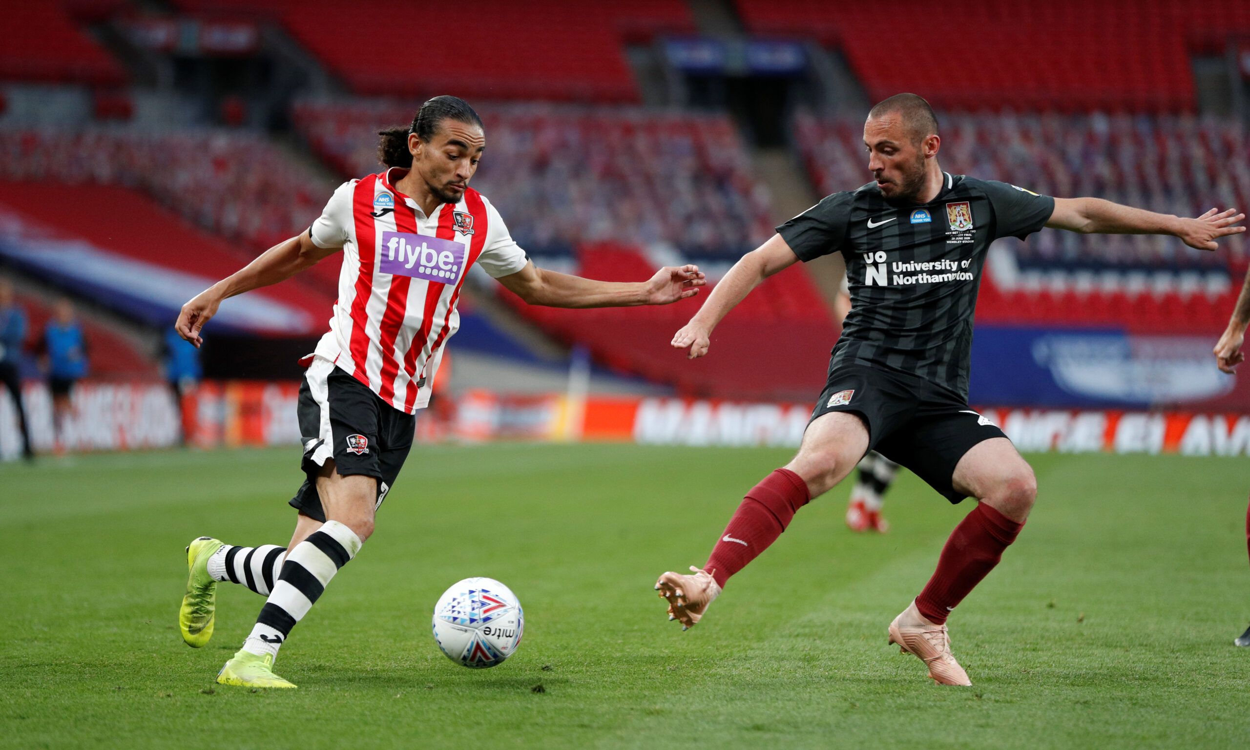 Soccer Football - League Two Play-Off Final - Exeter City v Northampton Town - Wembley Stadium, London, Britain - June 29, 2020   Exeter City's Randell Williams in action with Northampton Town's Michael Harriman, as play resumes behind closed doors following the outbreak of the coronavirus disease (COVID-19)   Action Images/John Sibley    EDITORIAL USE ONLY. No use with unauthorized audio, video, data, fixture lists, club/league logos or 