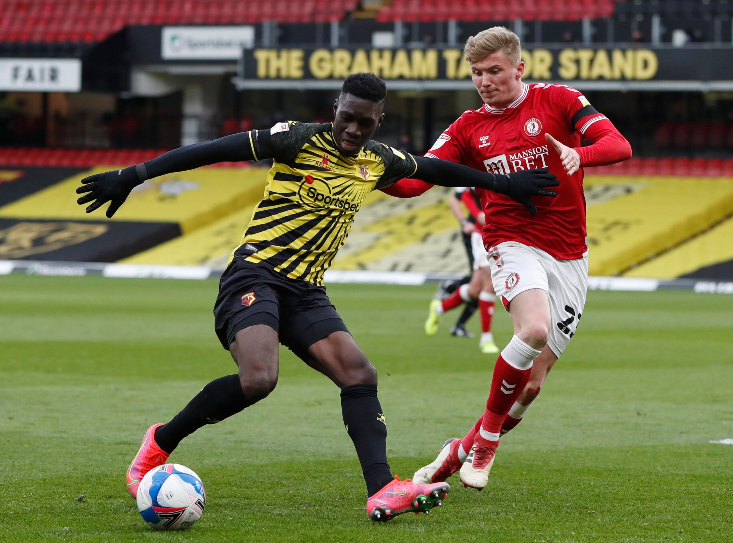Soccer Football - Championship - Watford v Bristol City - Vicarage Road, Watford, Britain - February 13, 2021 Watford's Ismaila Sarr and Bristol City's Taylor Moore Action Images/Paul Childs EDITORIAL USE ONLY. No use with unauthorized audio, video, data, fixture lists, club/league logos or 'live' services. Online in-match use limited to 75 images, no video emulation. No use in betting, games or single club /league/player publications.  Please contact your account representative for further deta
