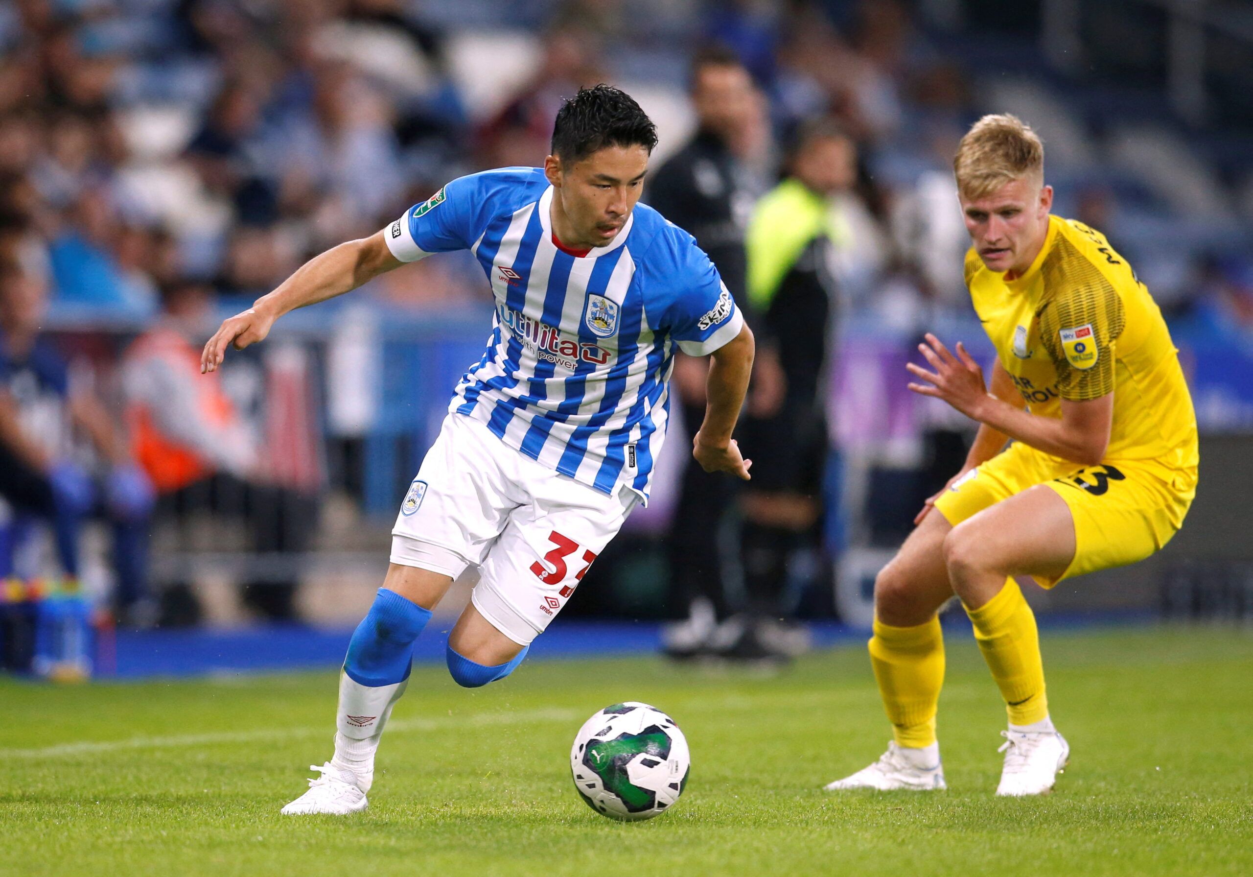 Soccer Football - Carabao Cup - Huddersfield Town v Preston North End - John Smith's Stadium, Huddersfield, Britain - August 9, 2022 Huddersfield Town's Yuta Nakayama in action with Preston North End's Ali McCann Action Images/Ed Sykes  EDITORIAL USE ONLY. No use with unauthorized audio, video, data, fixture lists, club/league logos or 
