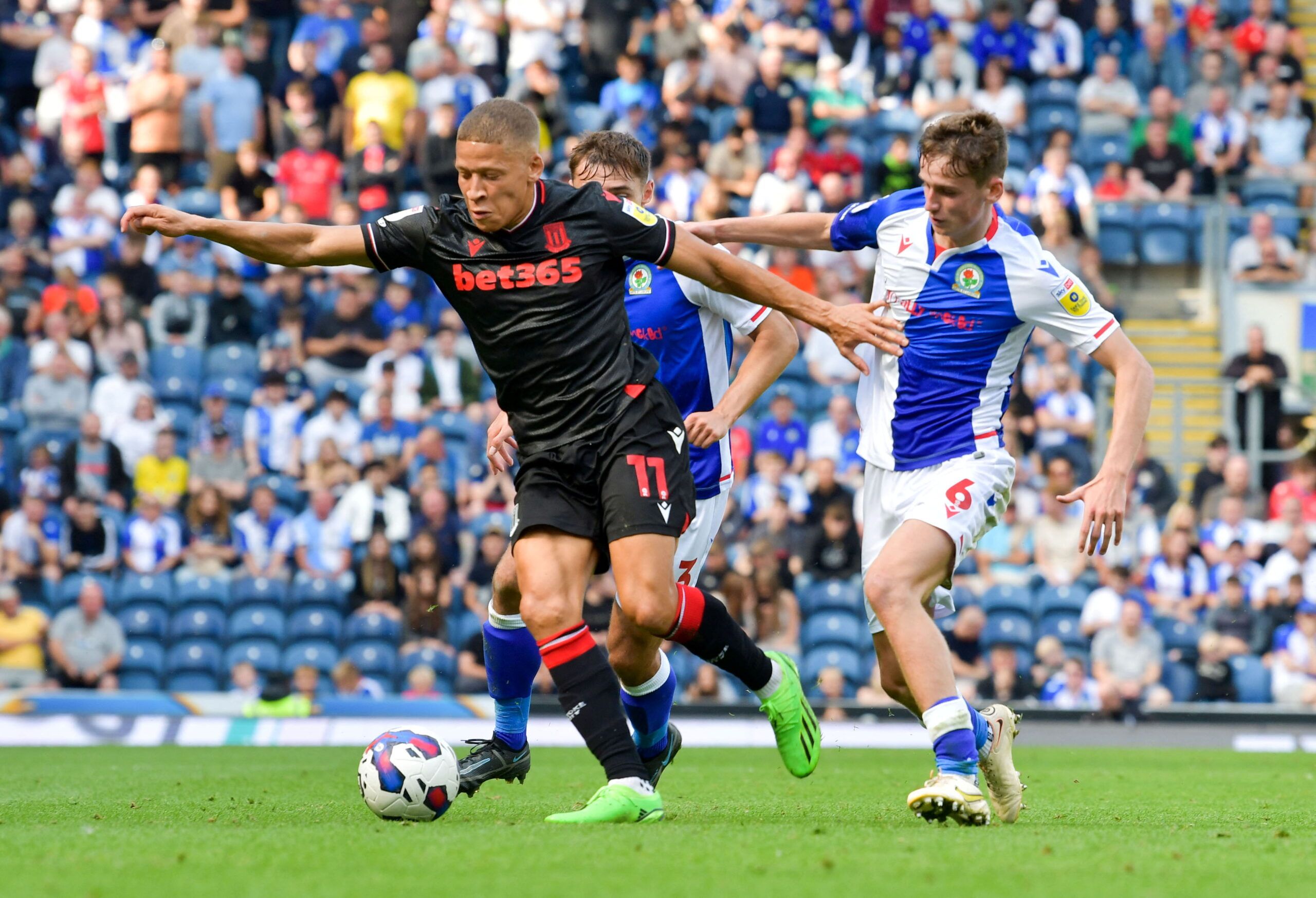 Soccer Football - Championship - Blackburn Rovers vs Stoke City - Ewood Park, Blackburn, Britain - August 27, 2022 Stoke City's Dwight Gayle in action with Blackburn Rovers' Tyler Morton Action Images/Paul Burrows  EDITORIAL USE ONLY. No use with unauthorized audio, video, data, fixture lists, club/league logos or 