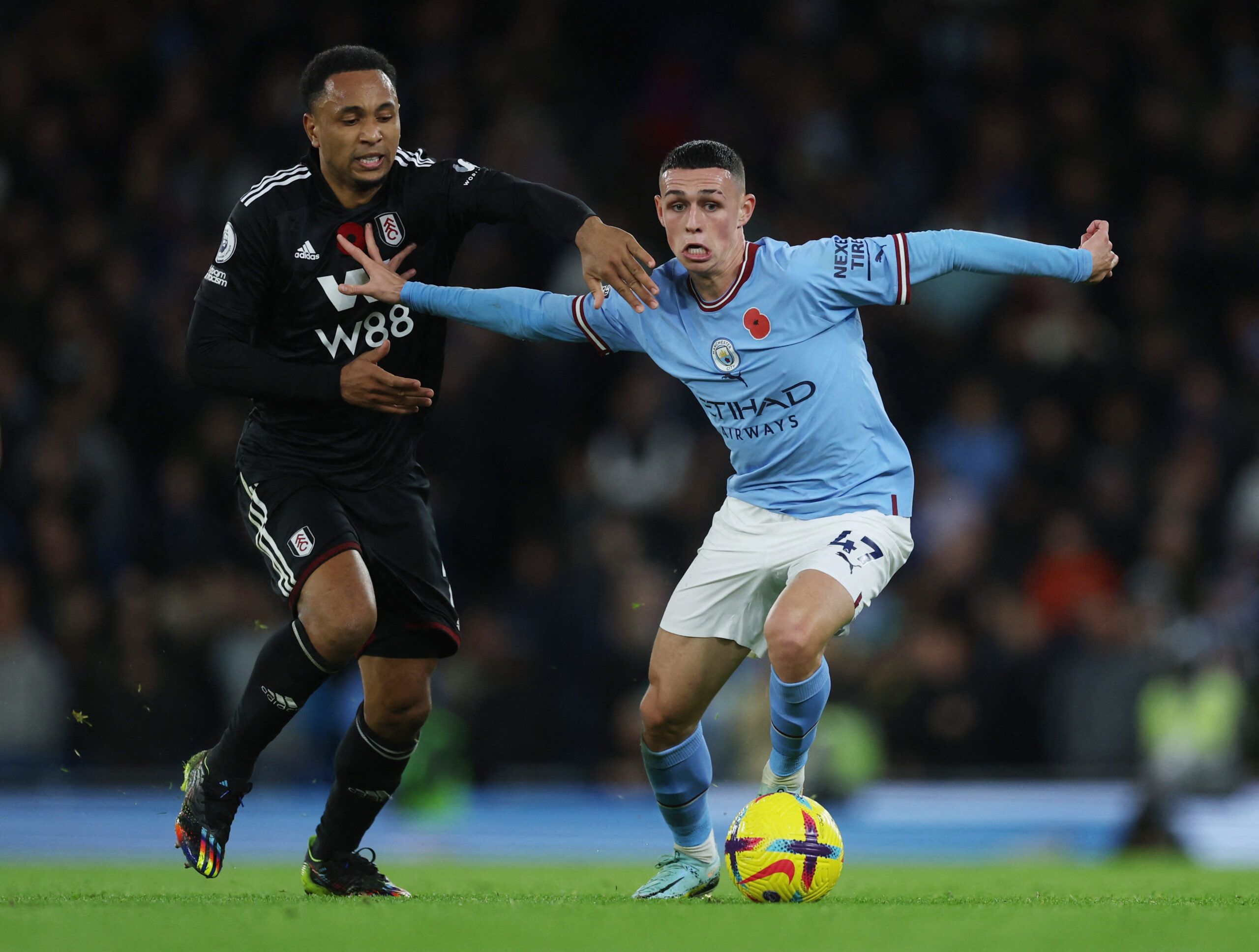 Soccer Football - Premier League - Manchester City v Fulham - Etihad Stadium, Manchester, Britain - November 5, 2022 Fulham's Kenny Tete in action with Manchester City's Phil Foden Action Images via Reuters/Lee Smith EDITORIAL USE ONLY. No use with unauthorized audio, video, data, fixture lists, club/league logos or 'live' services. Online in-match use limited to 75 images, no video emulation. No use in betting, games or single club /league/player publications.  Please contact your account repre